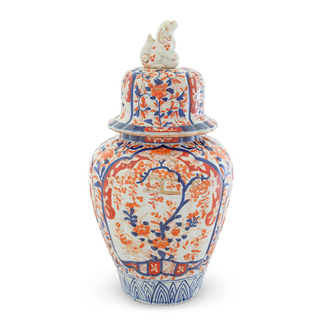 This is lovely Japanese Imari vase, hand painted in traditional Imari colors of cobalt and bittersweet. The vase is topped by a deep bell-shaped top with a finial in the form of a dog, 19th century.