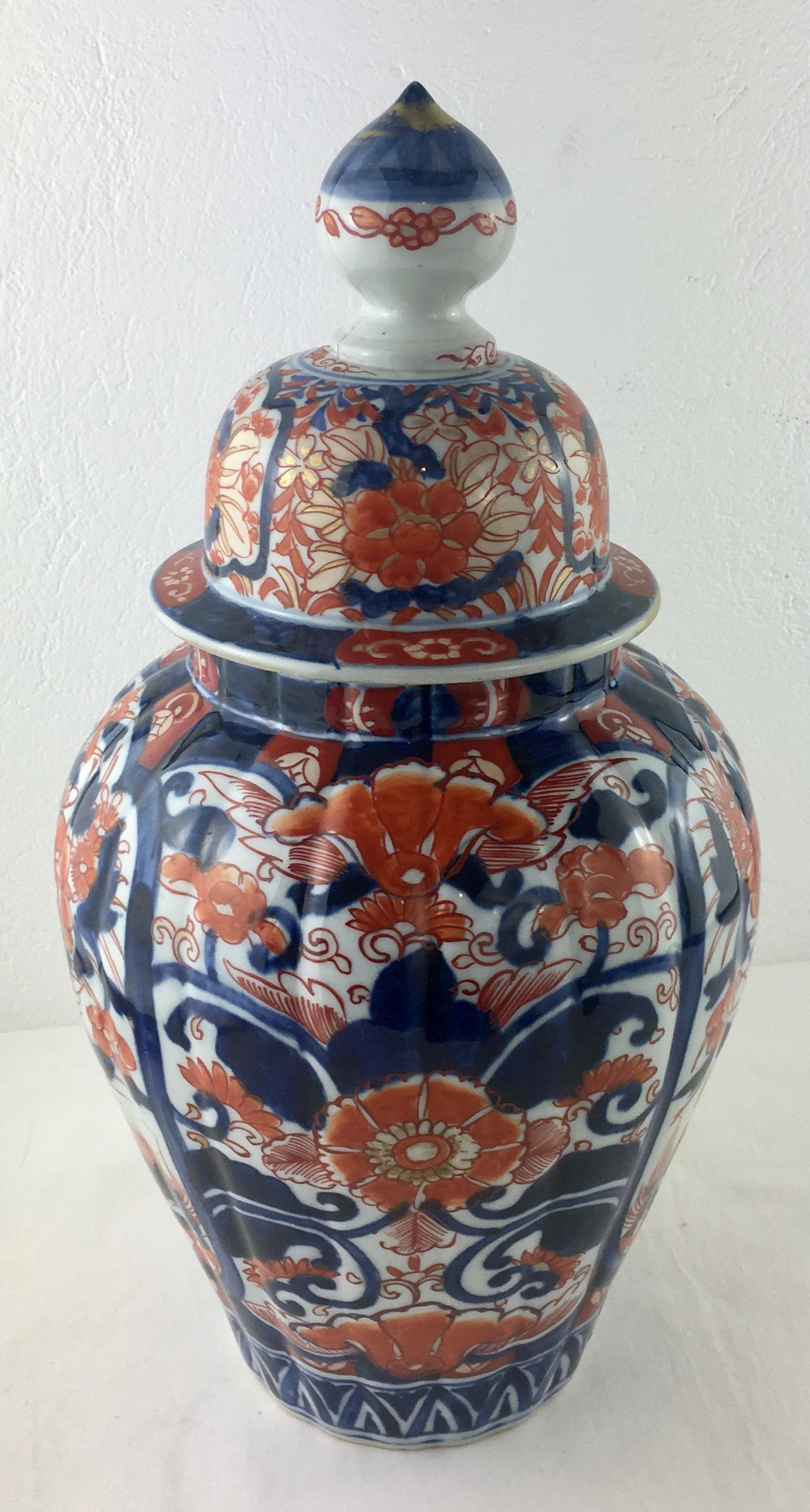 A very good quality 19th century Japanese Imari temple jar with a fluted form to the lid, classical motifs, ikebana flowers, foliage, ribbons and balls. 

This Meiji period decorative jar has a beautiful patina and like all of its kind is hand