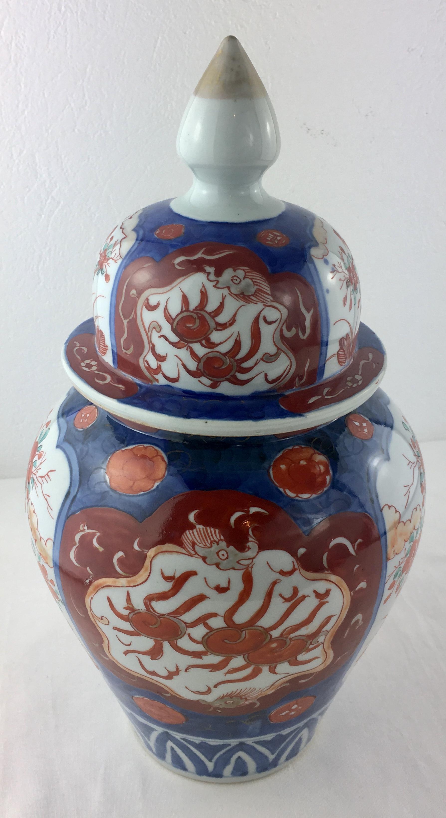 19th century Japanese Imari lidded vase one side has phoenix and ikebana flowers hand painted in great detail throughout. 

Colors from natural pigment glazes.
Beautiful patina. 

Very good antique condition. 
Measures: 12