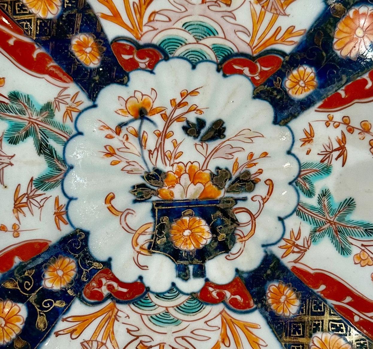 A very nice 19th Century Japanese Imari plate with a scalloped edge. The design has a beautiful hand painted urn in the middle with flowers in very good quality. Circa 1890s.