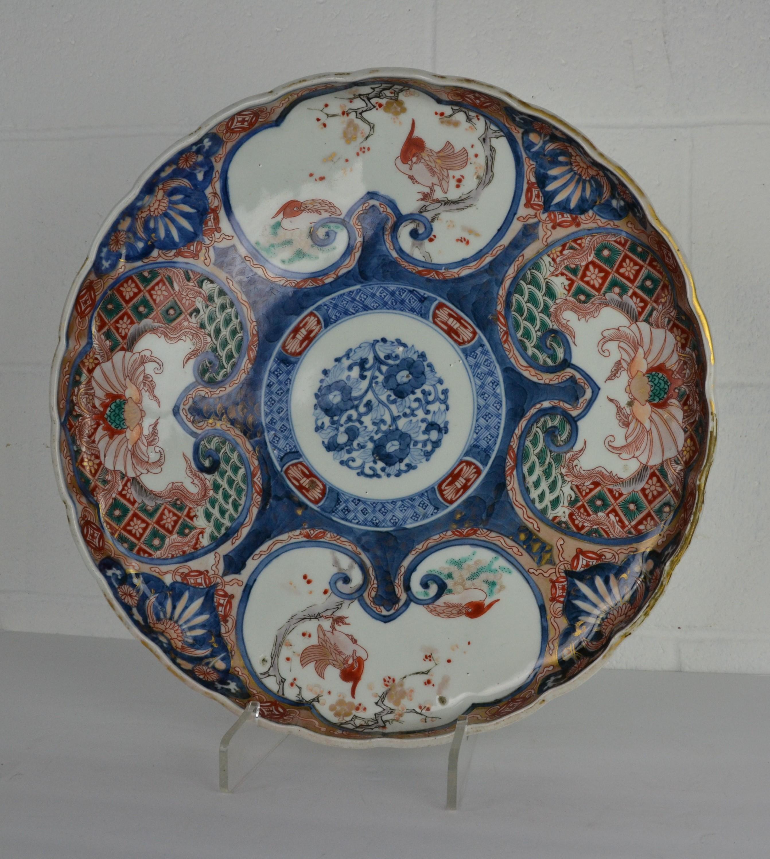 A large Japanese 4 color platter. Late 19th century with character marks. White ground panels decorated with birds. Vertical 