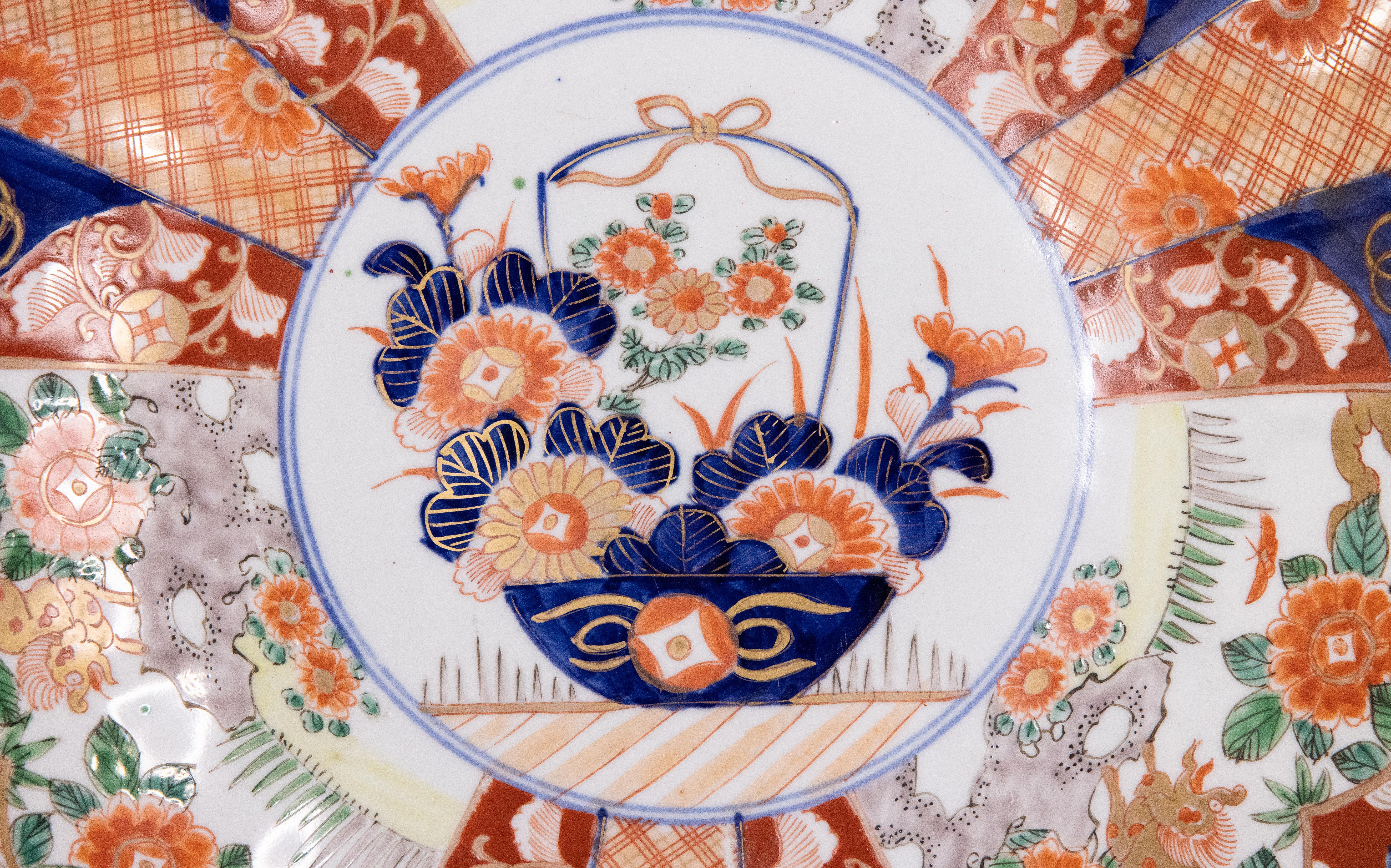A gorgeous 19th-Century Japanese Imari porcelain charger with a hand painted floral design in the traditional Imari colors. This fine large plate has lovely scalloped edges and is quite heavy, weighing over 3 lbs. It's in excellent condition and