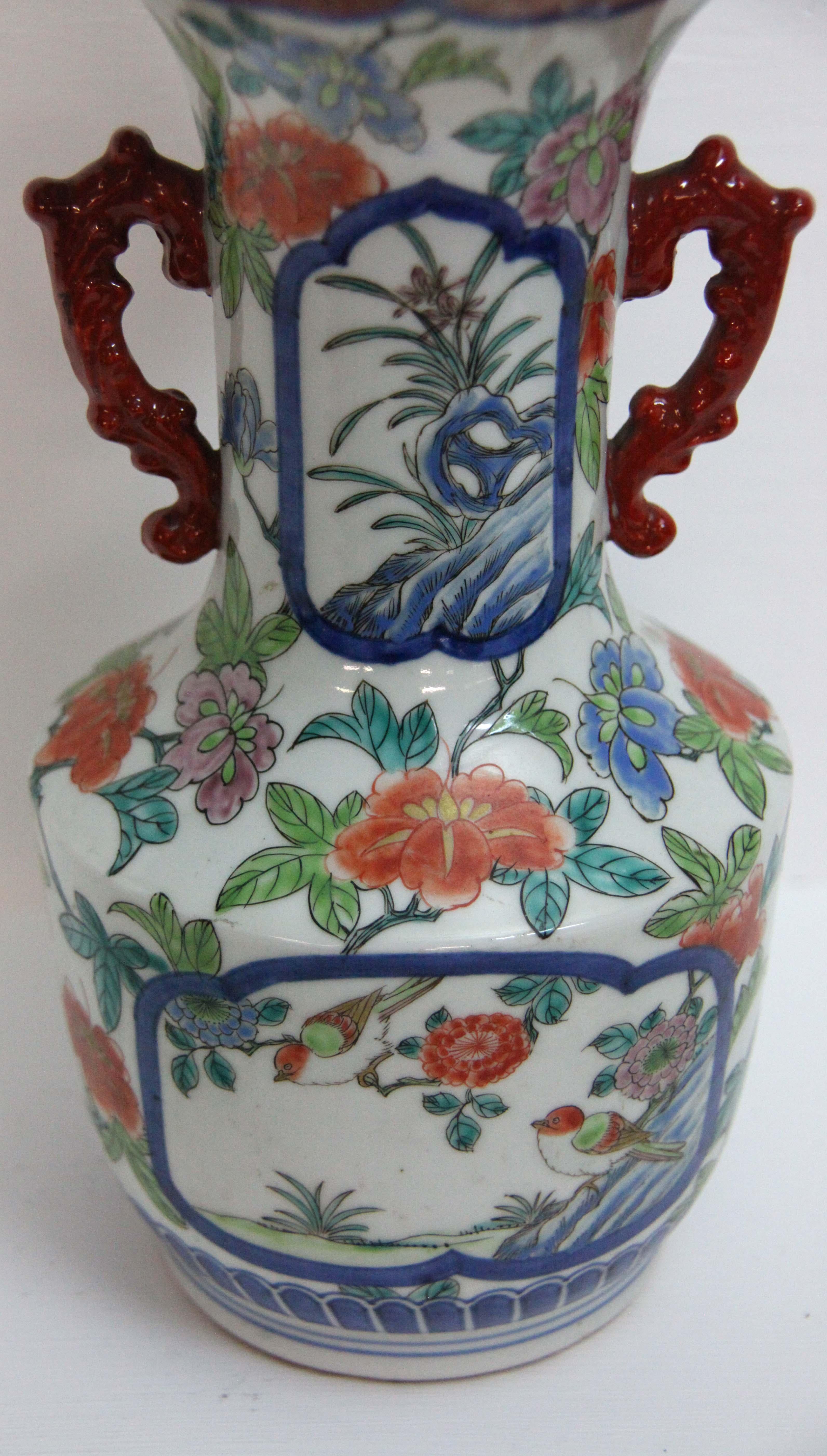 19th century Japanese Imari two handle vase, with flowers, birds, leaves and vines throughout, flared neck and shaped rim.