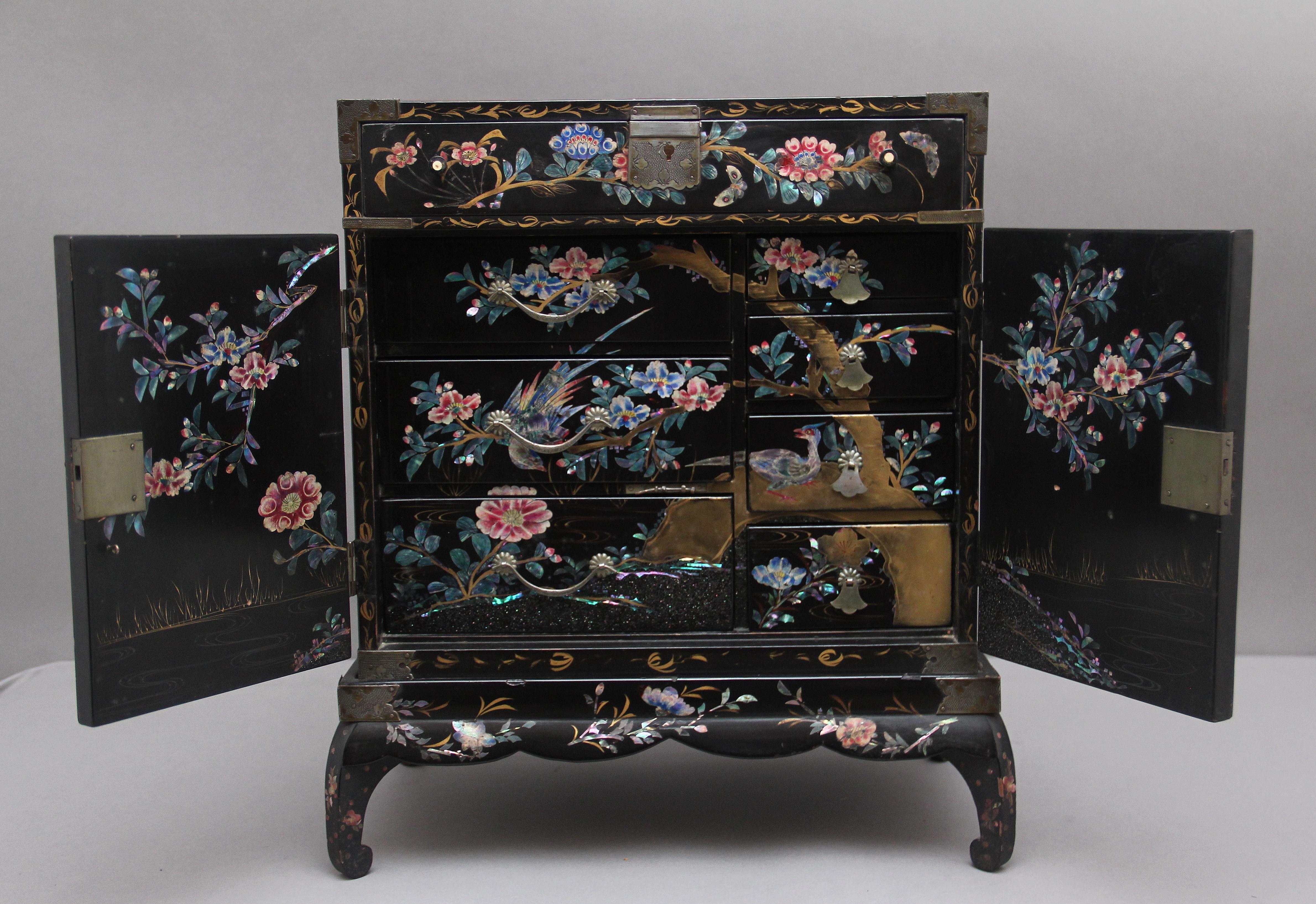 19th Century freestanding Japanese black lacquered table top cabinet on stand (Ko-dansu) from the Meiji period (1868-1912) profusely inlaid all over with floral inlay, with the top of the cabinet and the front door panels having a detailed nature