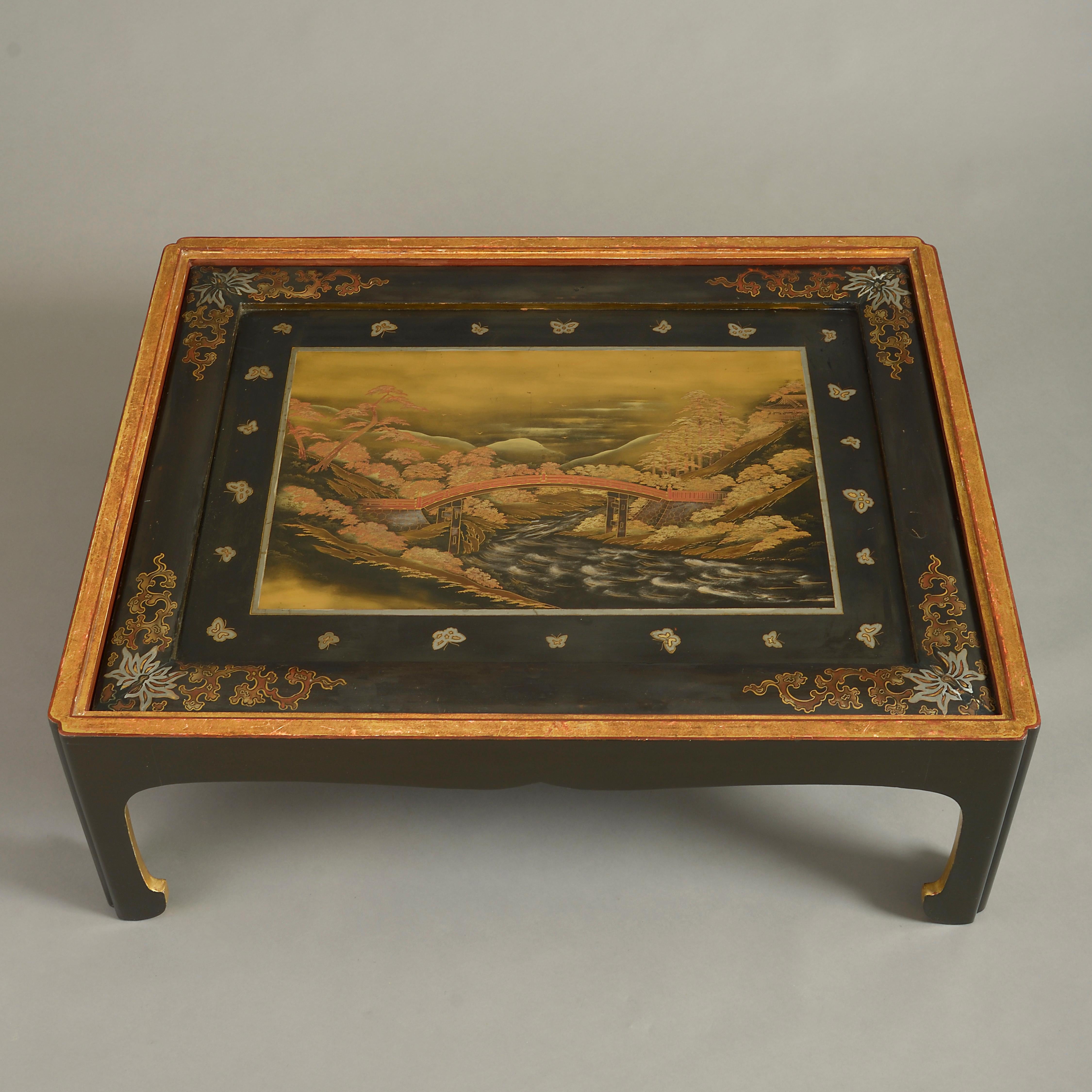A late 19th century Japanese lacquer panel, depicting an imaginary river landscape with footbridge, set within a rectangular frame with fret cut legs as a low or coffee table.

This low table was most probably made in the second half of the