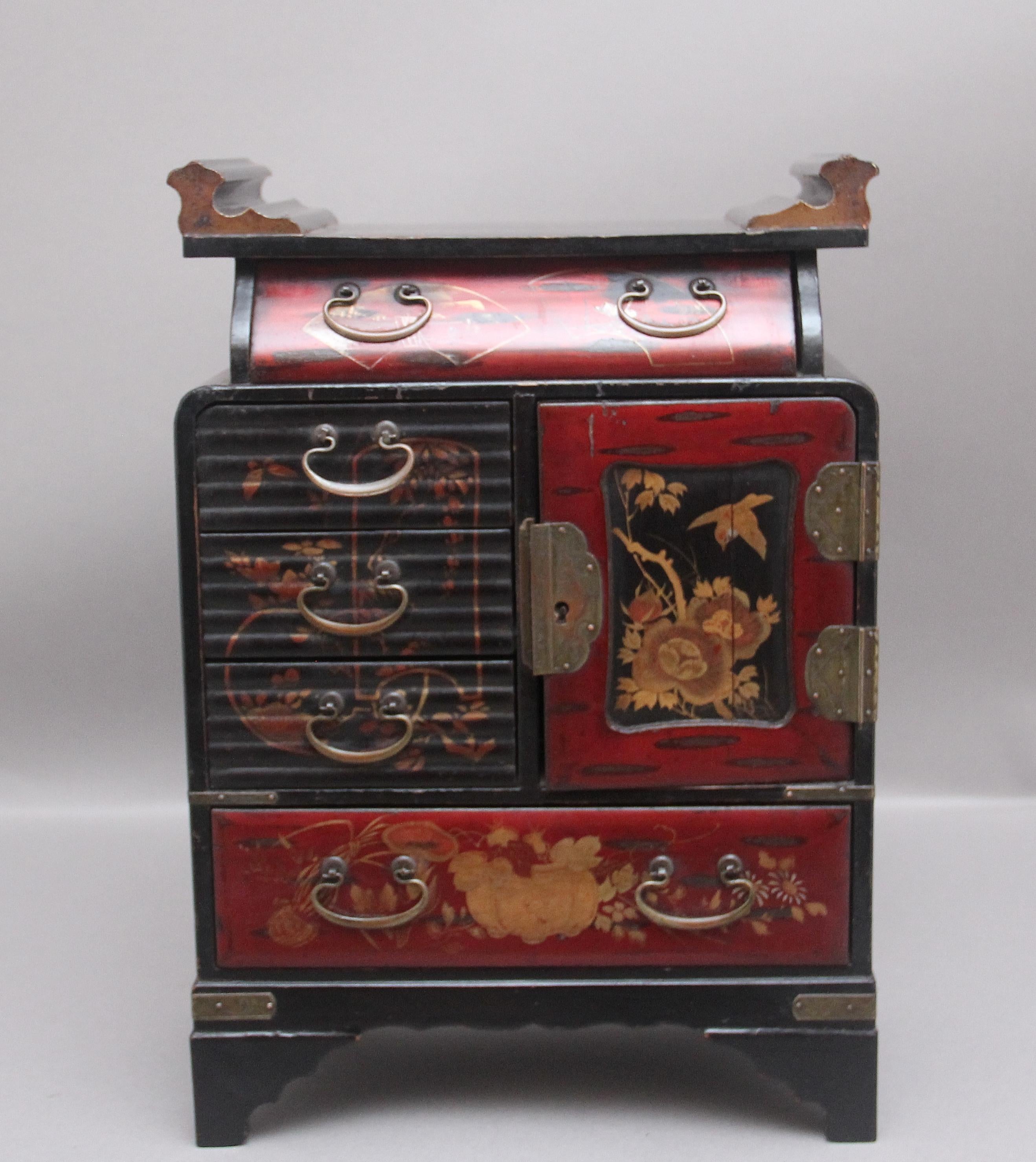 19th Century Japanese lacquered table cabinet from the Meiji period, having a shaped top in the typical Japanese style, the top, sides and front lacquered with floral decoration, the front of the cabinet consisting of five various size drawers with
