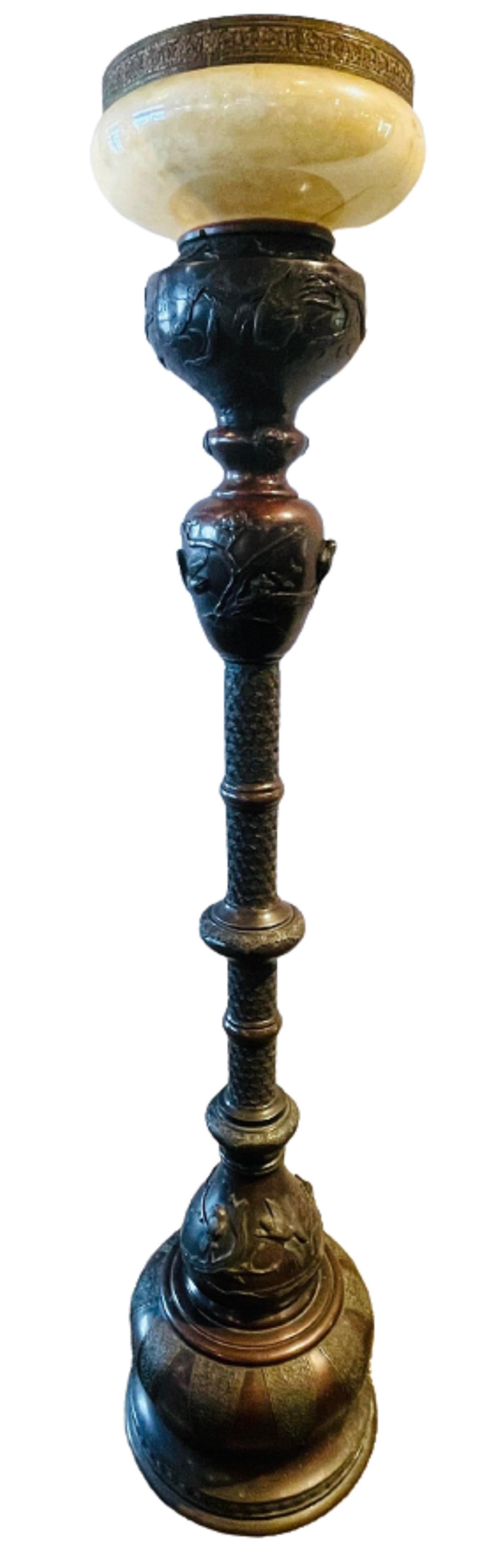 A 19th century Japanese Meiji bronze torchiere or floor lamp with foliage and bird relief.  Original globe missing - item priced accordingly.

