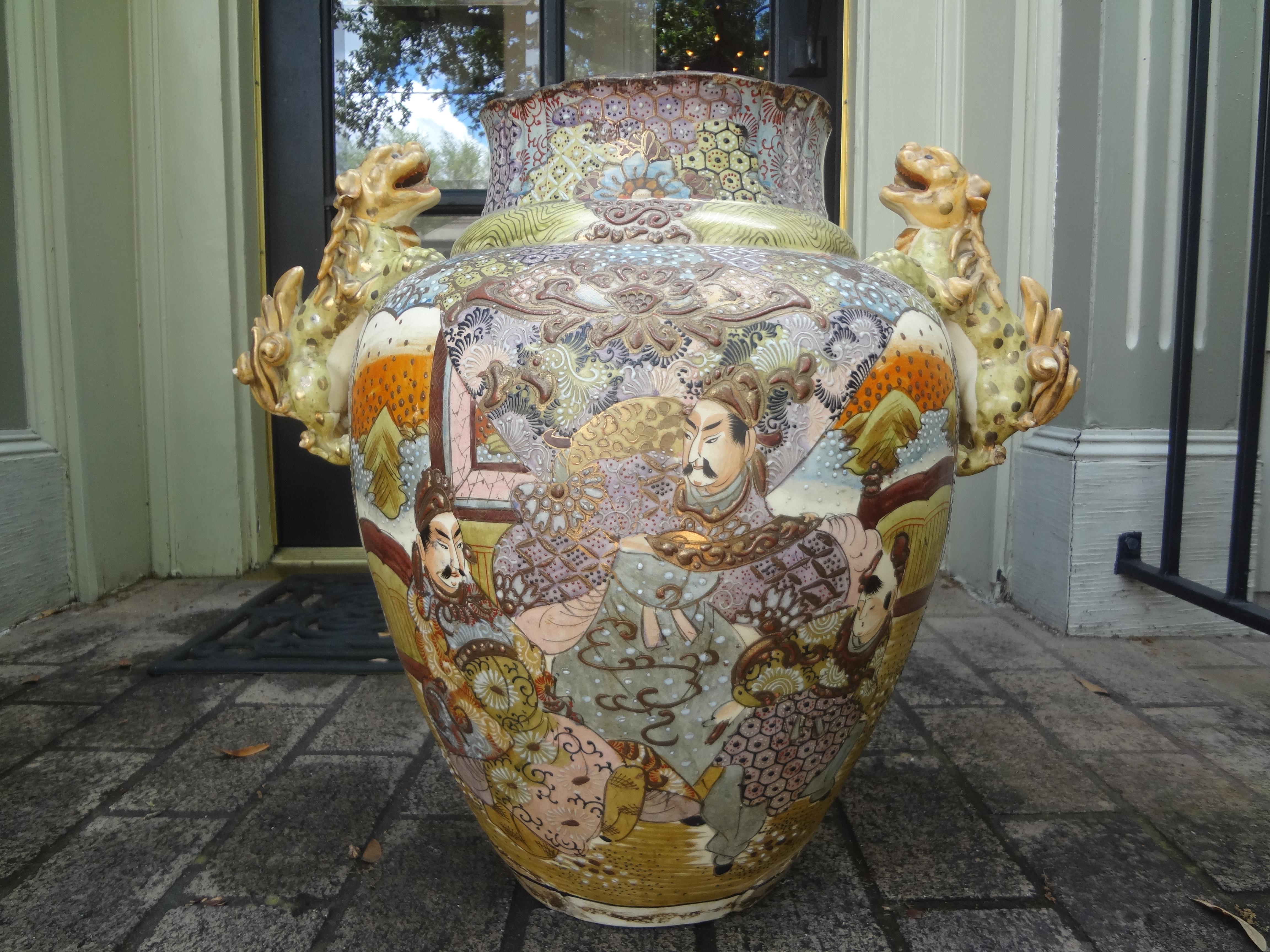 19th century Japanese Meiji palace urn with foo dog handles.
Stunning large antique Japanese Meiji period palace urn with foo dog handles. This gorgeous Asian Satsuma style urn is beautifully decorated in unusual raised pastel colors with foo dog