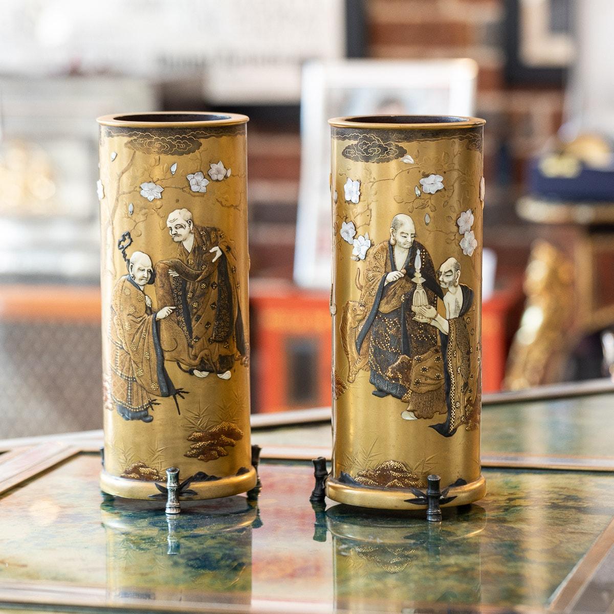 Antique late-19th Century Japanese Meiji period pair of very fine gold lacquered vases of cylindrical form, decorated with shibayama inlaid, each one decorated with scenes of Japanese immortals, inlaid with a birds and flowers, on a kinji ground