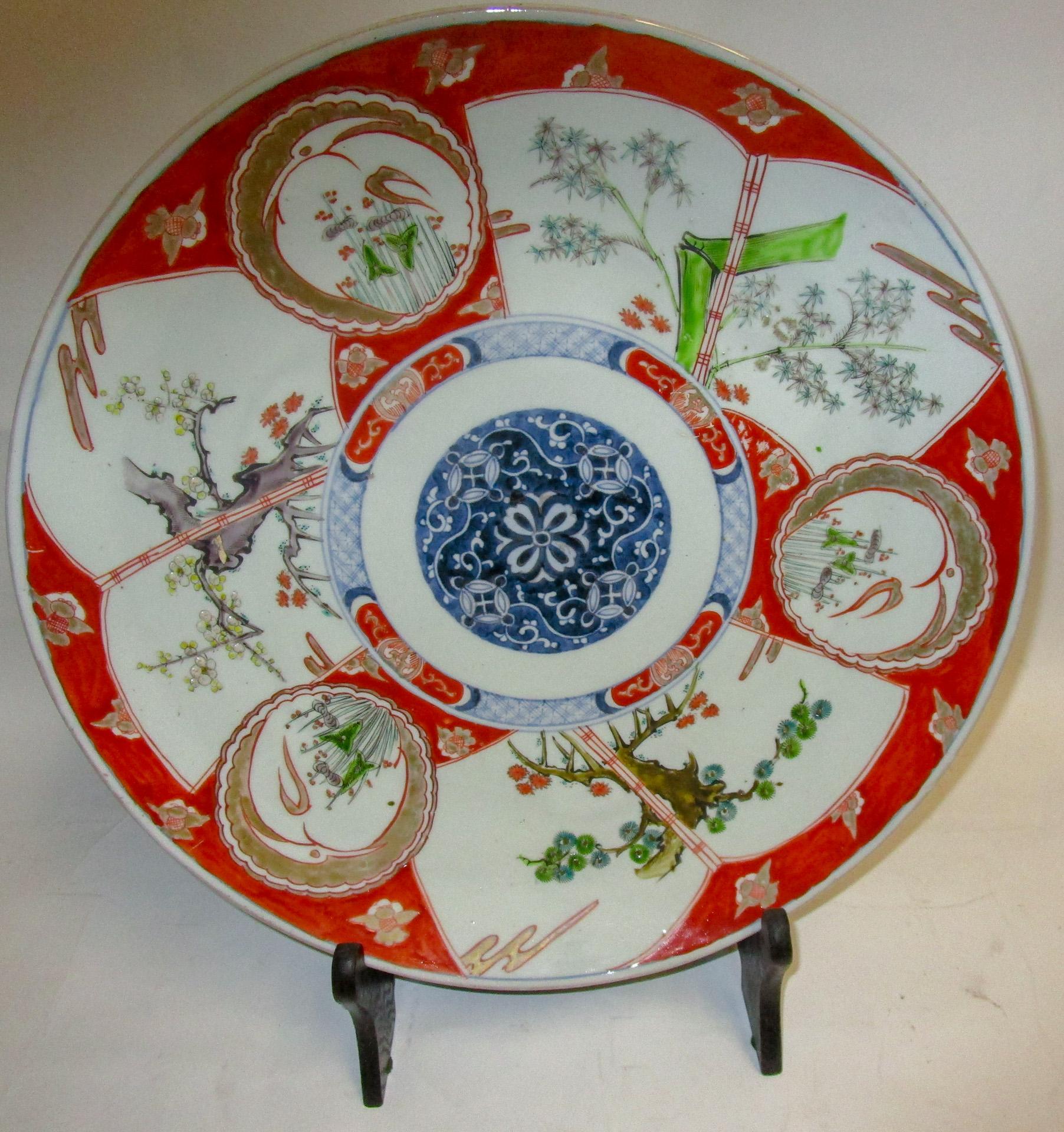This handsome Japanese Porcelain charger dating from the Meiji era (1868-1912) is boldly hand painted with deep rich blue and cinnabar enamel with unusual green accents. The platter features a blue center medallion, various other designs and