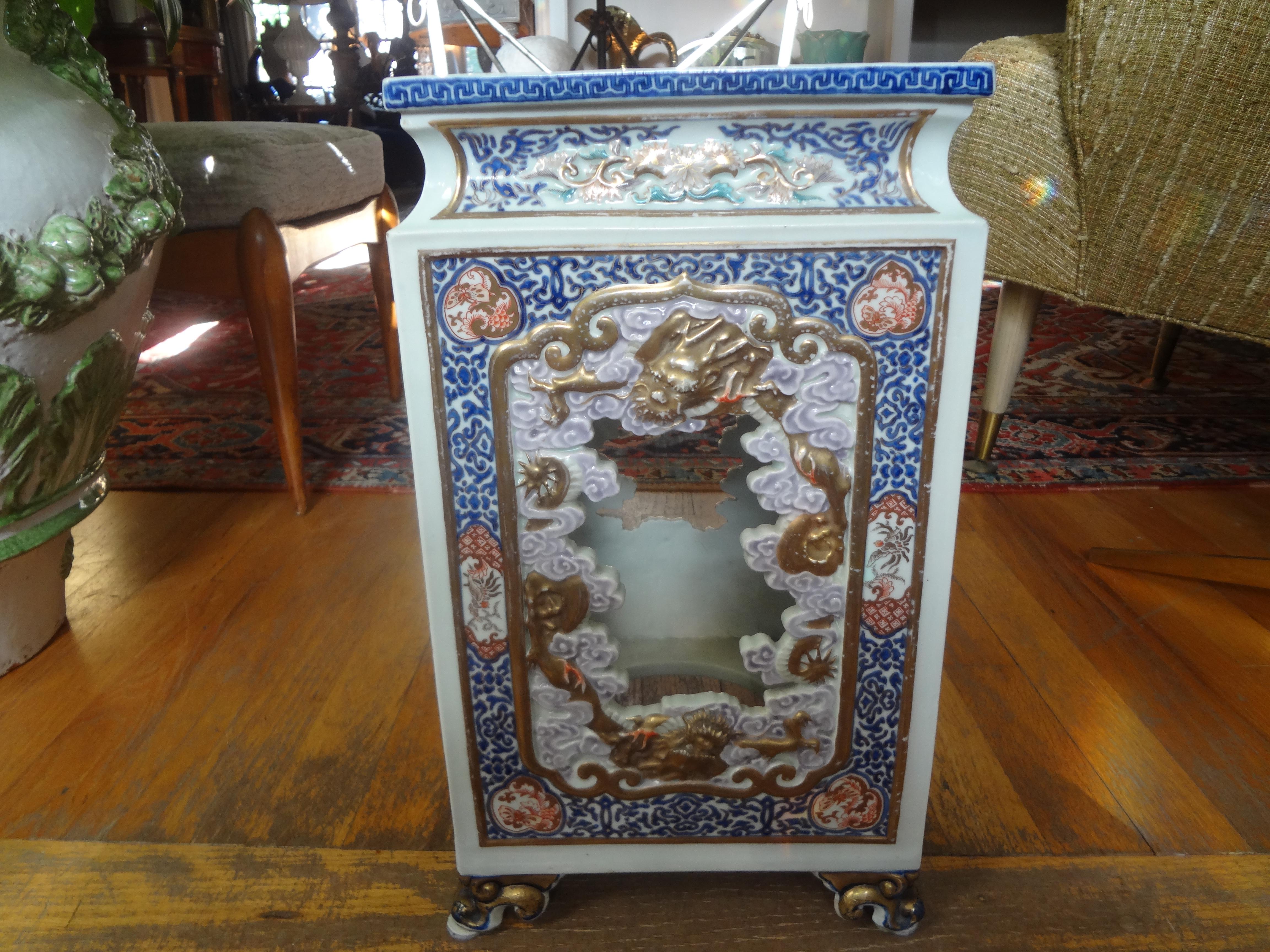 Stunning 19th century Japanese Meiji period hand decorated porcelain garden seat, garden stool or table. This antique Japanese garden seat is beautifully detailed with gilt trimmed feet and Greek key accents. This would make a perfect side table.