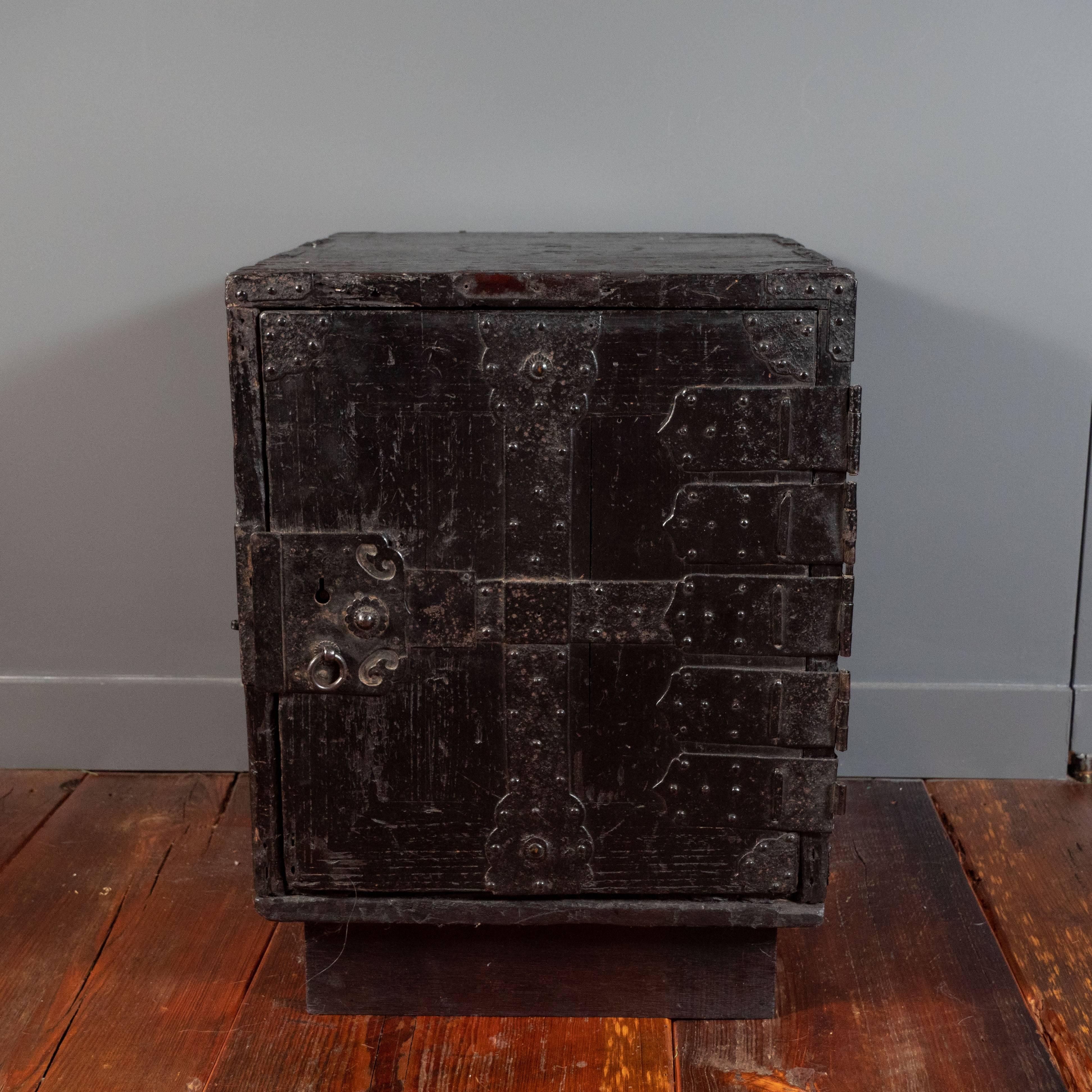 19th century Japanese safe, Meiji period. Early safe also used as a side table in recent times. The original black lacquer and strap hardware. Inside main door reveals small drawers: two missing.