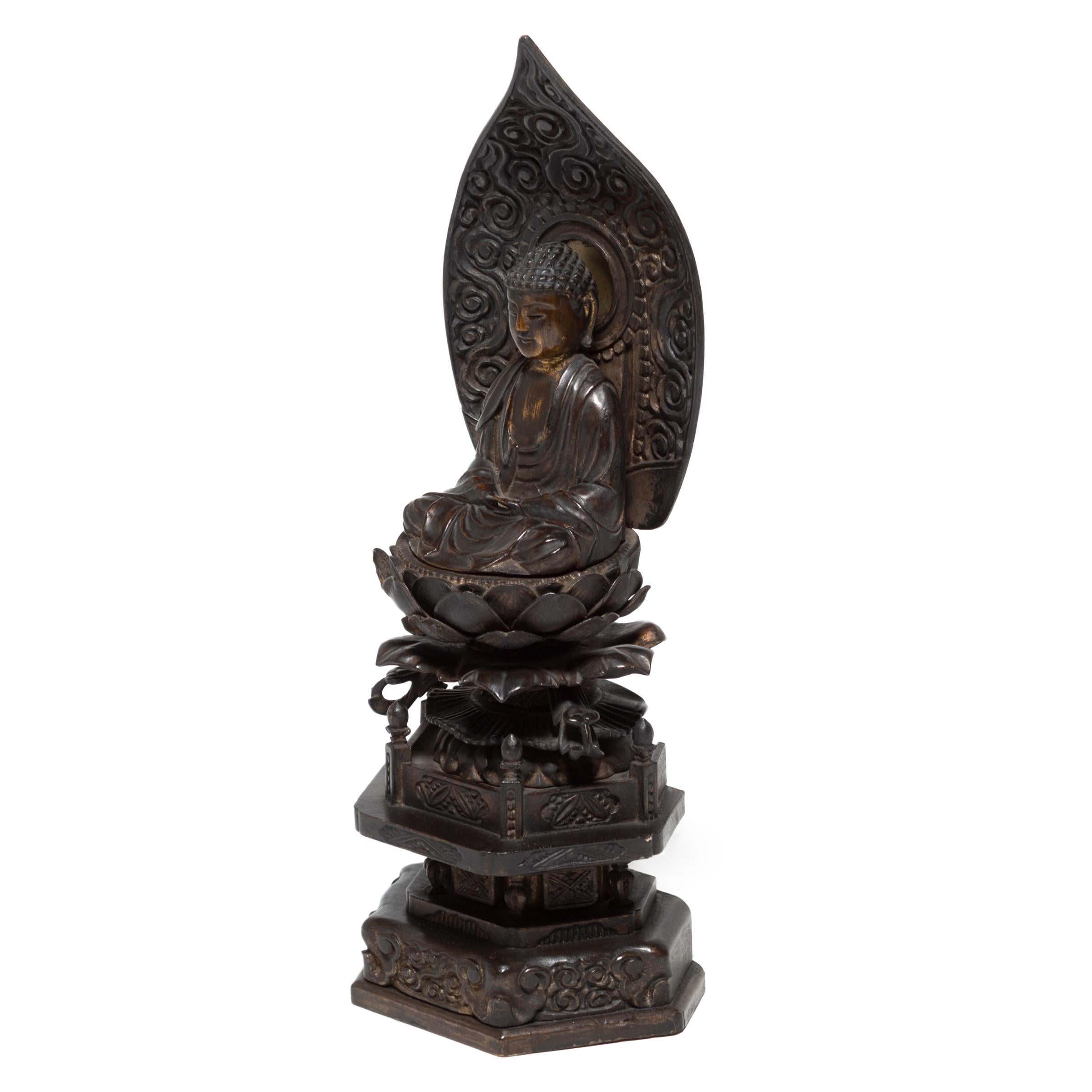 This intricately carved seated figure depicts the Amitābha, the Buddha of Infinite Light. Known also as Amida in Japan, he is the oldest and most important of the five celestial Buddhas of Mahayana Buddhism. Amida symbolizes the transformation of