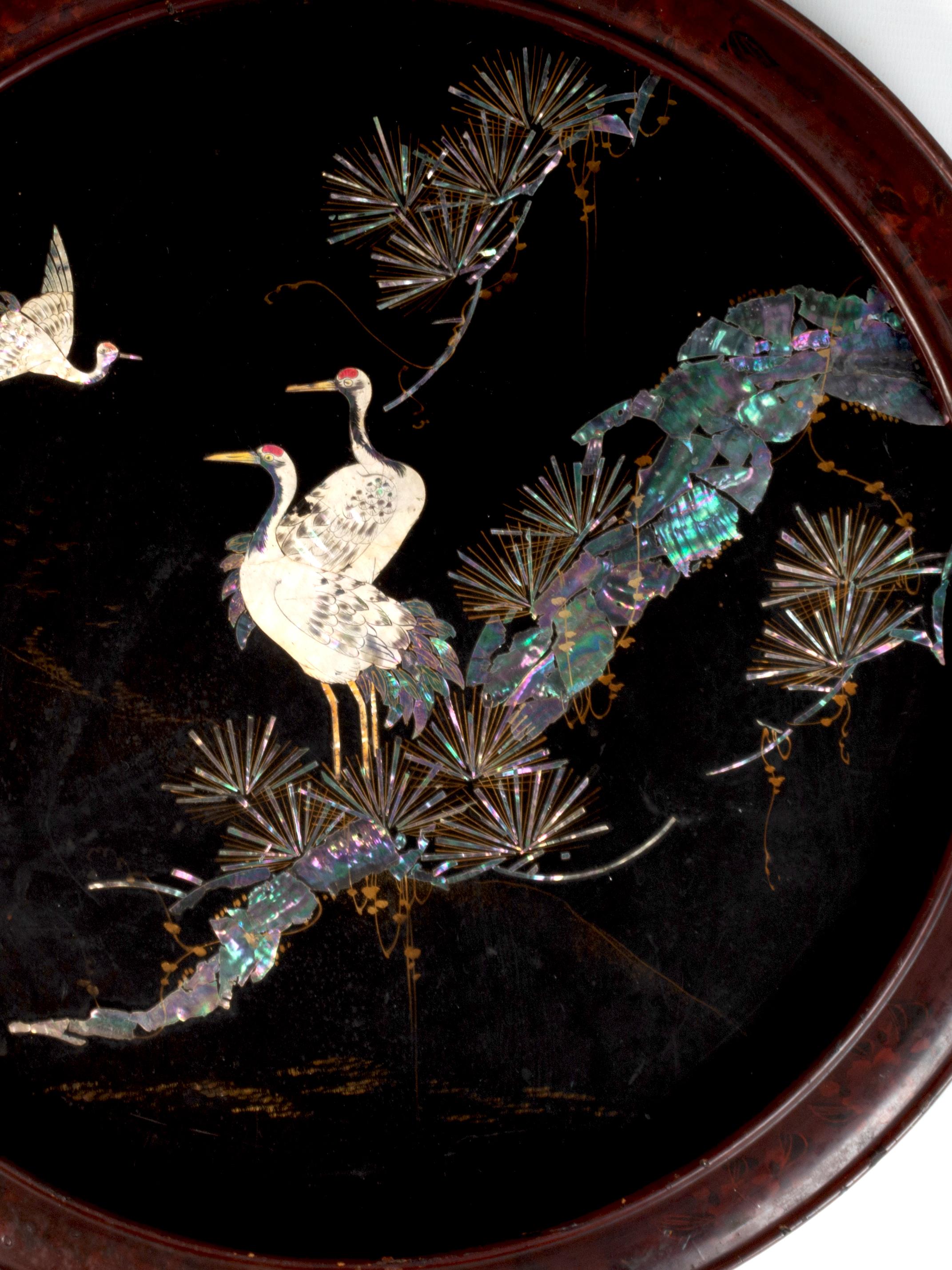 19th Century Shibayama Lacquered Inlay Charger, Meiji Period, Japan

A decorative 19th Century Japanese charger beautifully depicting herons and pine trees detailed in mother of pearl and bone on a lacquered ground. Presented in the original red