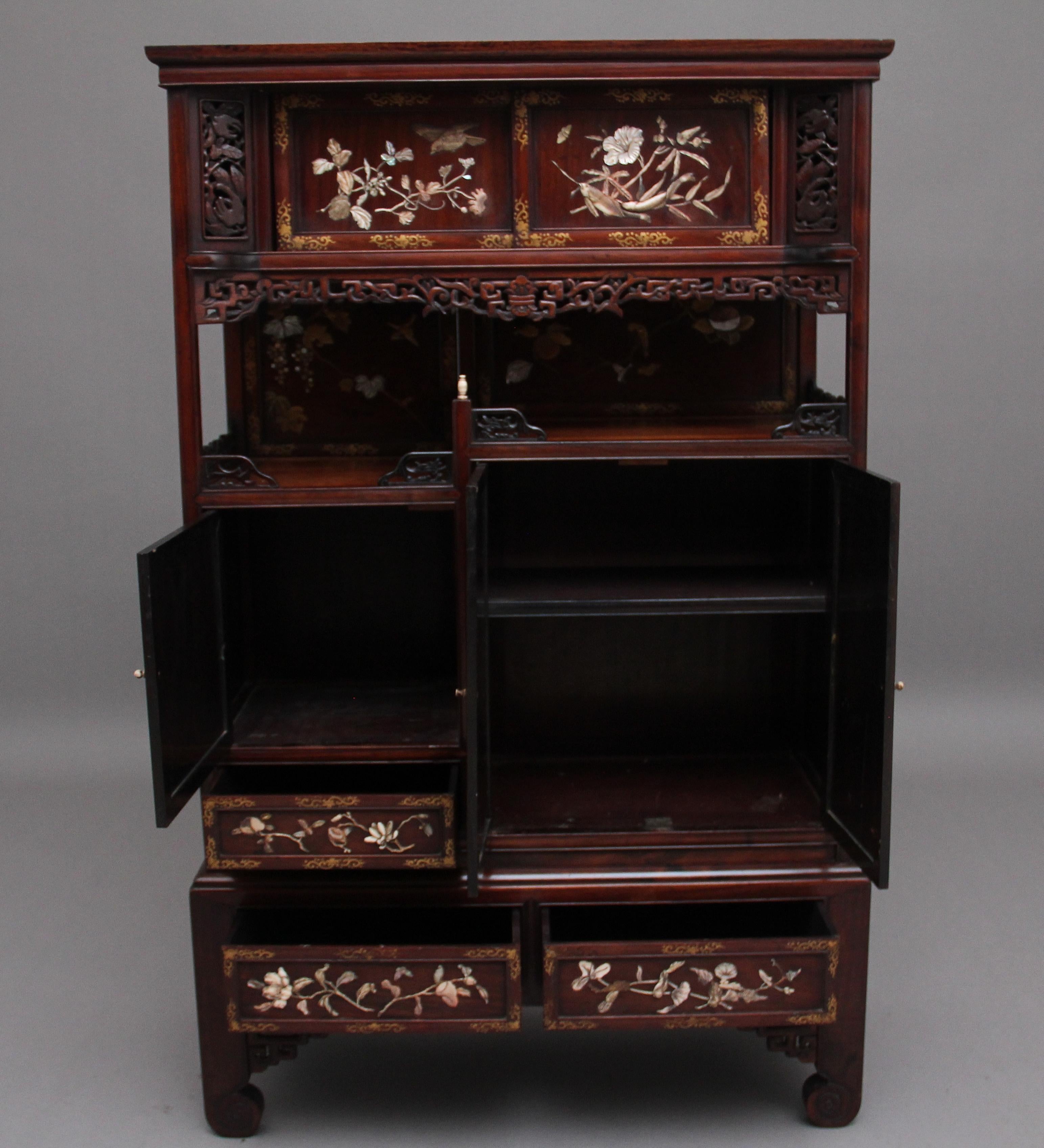 A superb quality 19th Century Japanese Meiji period shibayama shodhana, the rectangular top above a pair of sliding doors, a stepped niche and an arrangement of further panel doors and short drawers, profusely inlaid and applied throughout with
