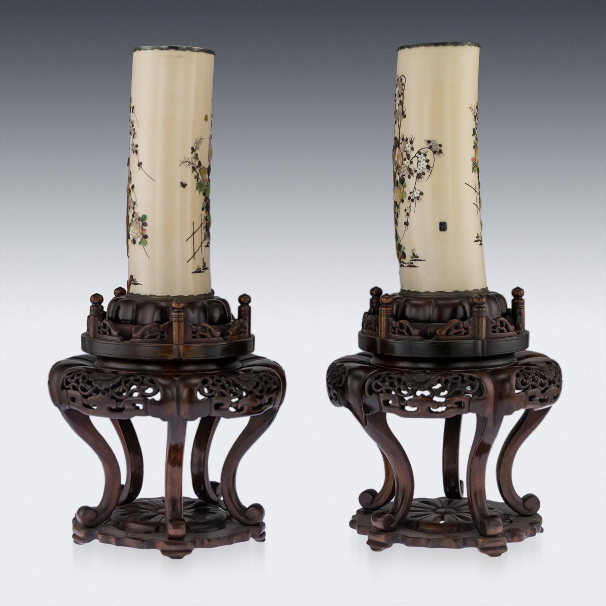 Description

Antique late-19th century Japanese Meiji period shibayama pair of vases on elaborate stands, tops applied with pierced silver rims and bases with revolving top carved wood stands, the sides of each vase intricately inlaid, one side