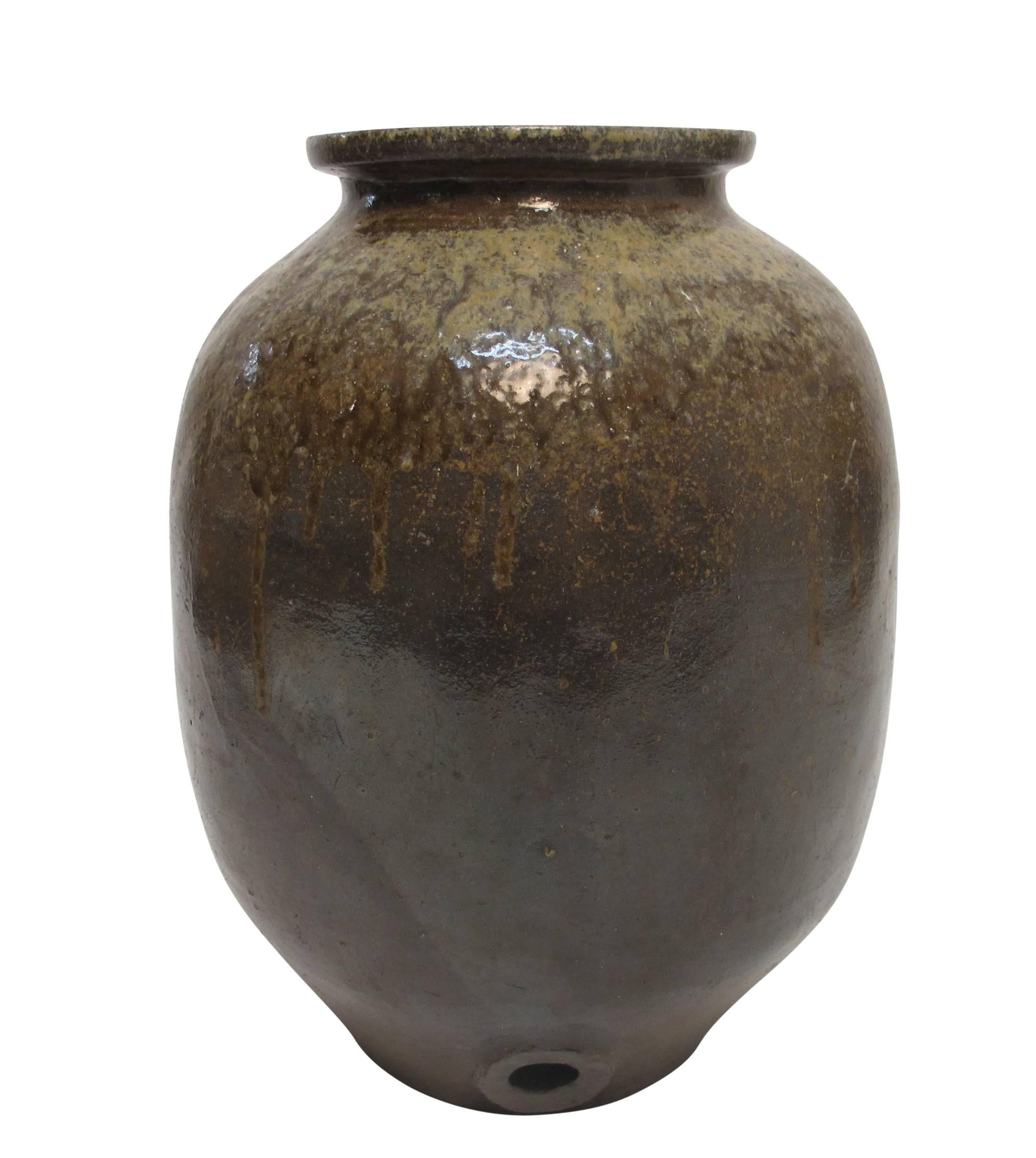 A large heavily glazed stoneware sake jar or pot. Wonderful colors and shape. Presumedly the hole on the side would have had some kind of spout originally, Japan, 19th century.