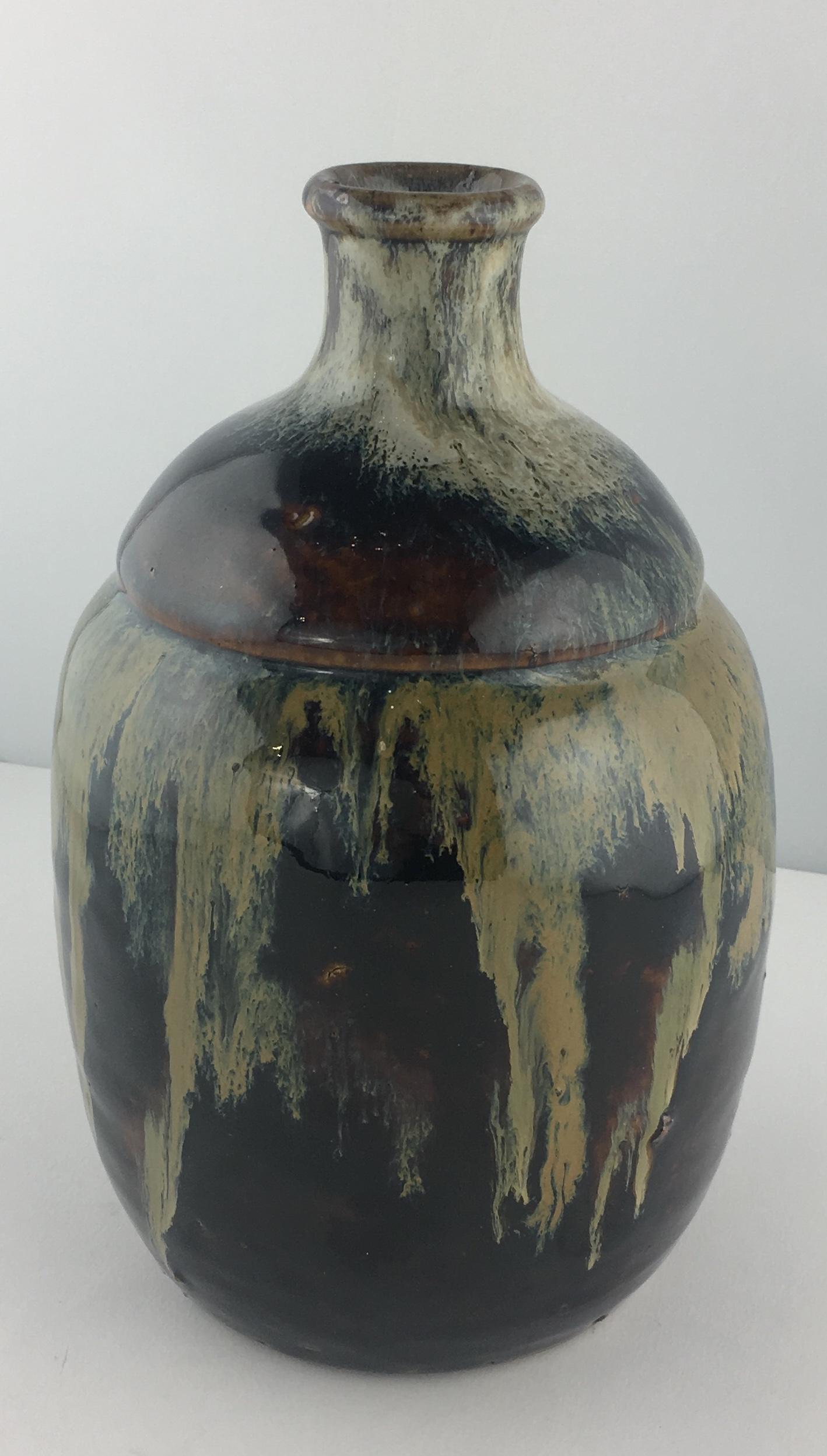 A large heavily glazed stoneware saki jar or pot. 

This traditional Japanese piece has wonderful colors and a beautiful shape, 19th century.
 