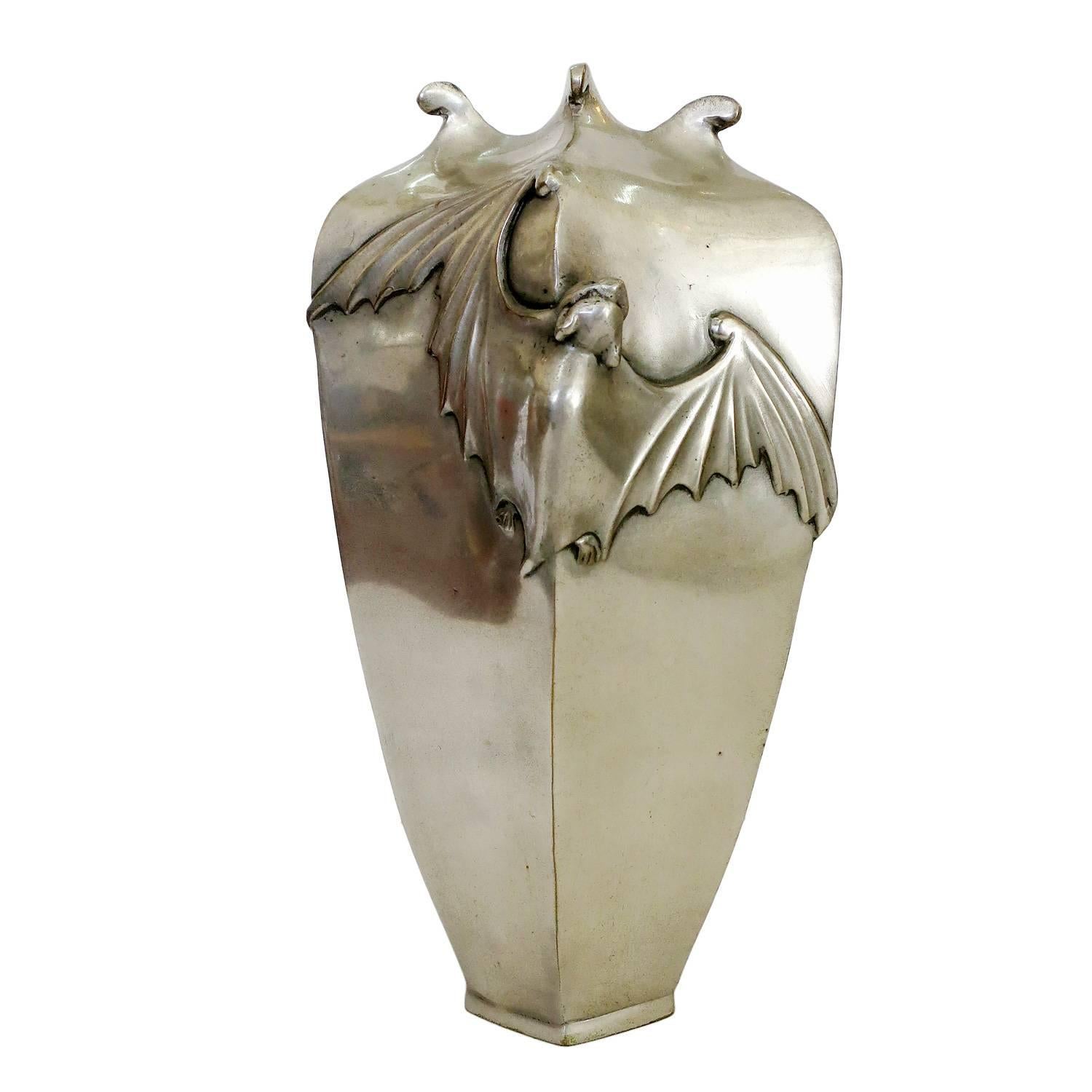 Casting from an original antique Japanese vase that was made in 1890 this solid bronze vase is finished in antique silver. The six-sided, tapered design with rolled tips at the opening features a bat spreads across two sides with an Art Nouveau