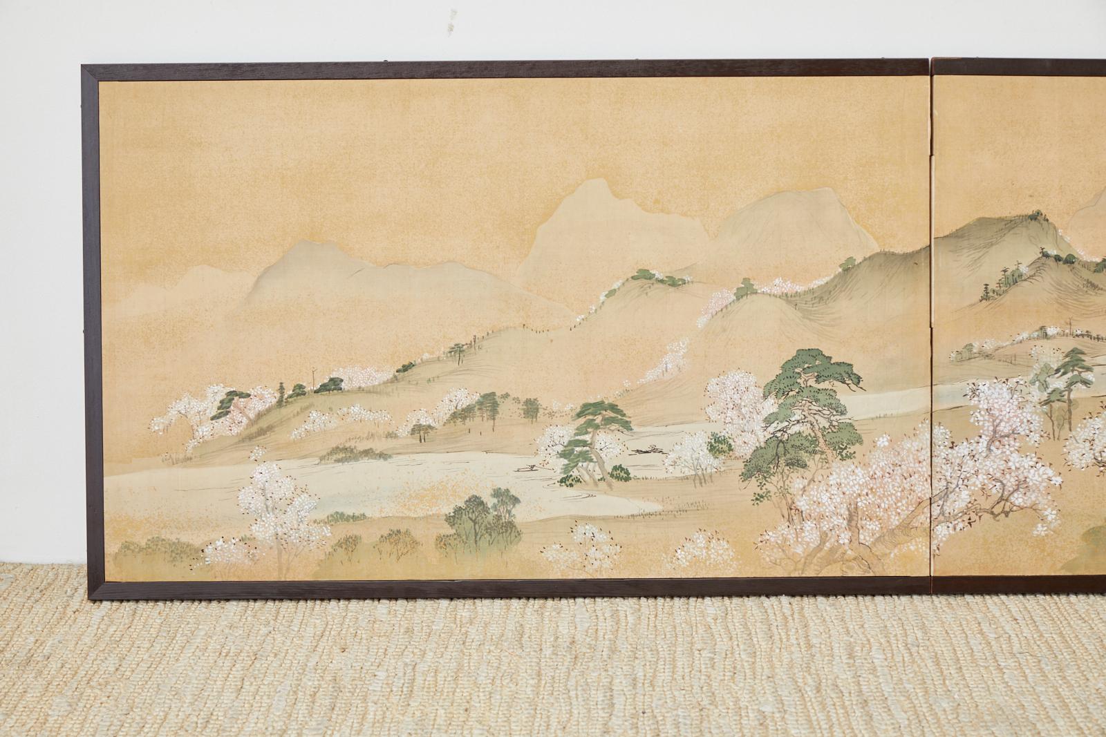 Edo period serene Japanese two panel landscape screen depicting blossoming Cherry or Sakura trees at Yoshino. 19th century painting by Kanno Shinsai signed with seal and cyclical date of late winter 1856 (hinoe-tatsu) ink and color pigments with