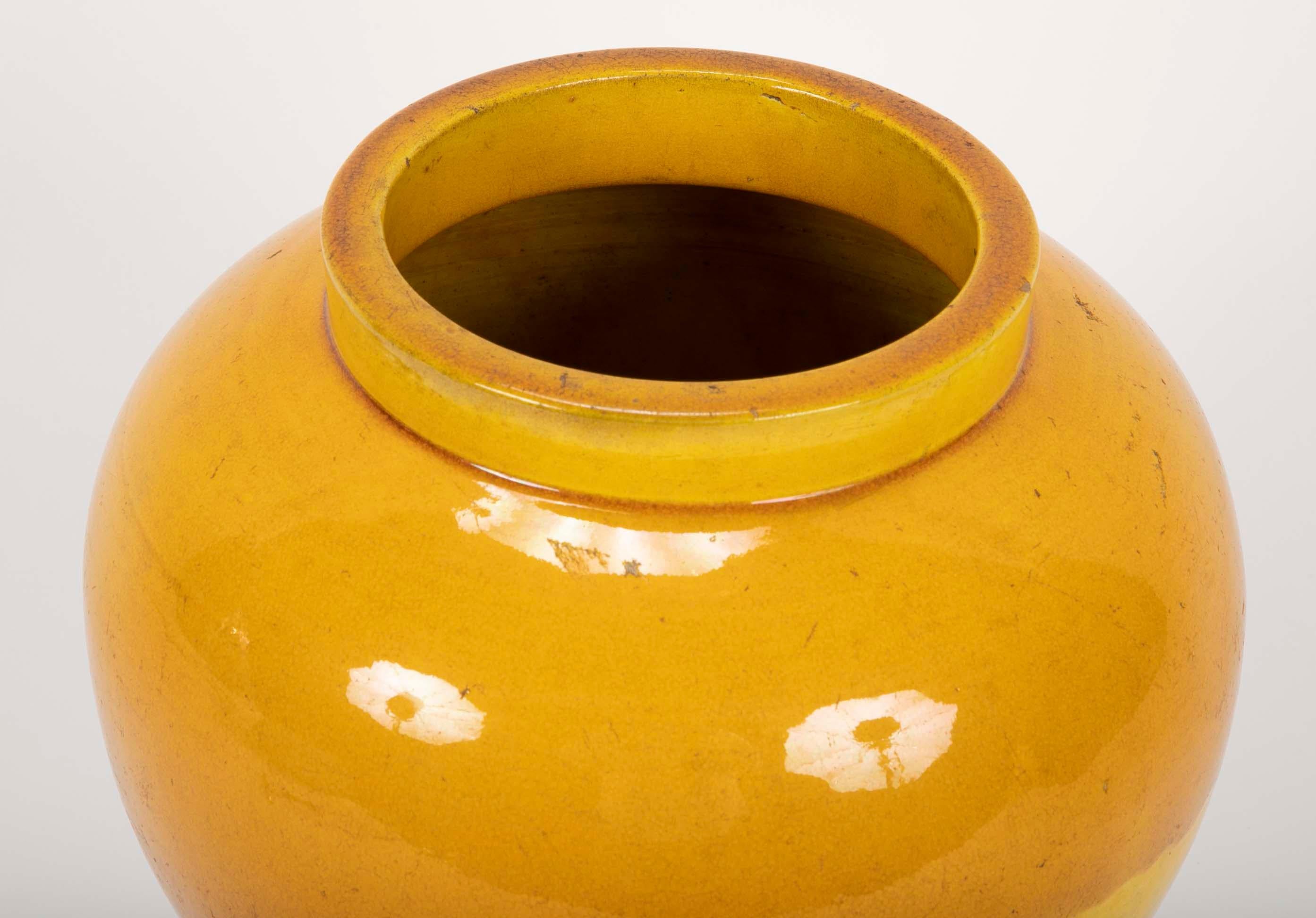 Japanese glazed ceramic vase in form similar to a Chinese ginger jar. The beautiful yellow glaze with a rich caramel over-glaze on the top part of the jar. A wonderful shape and stunning color. Though dating from the late 19th century this vase has