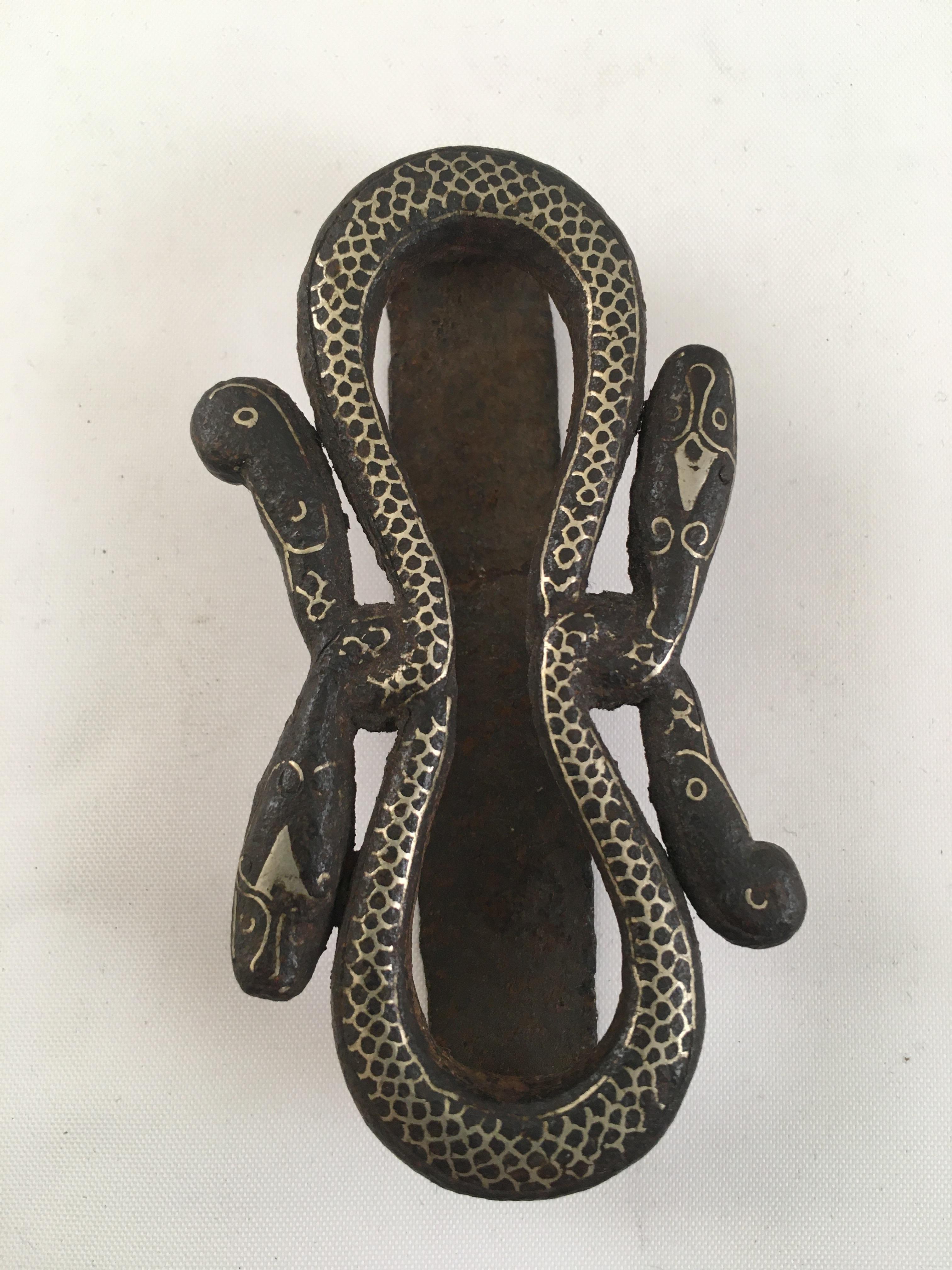 An antique java Surakarta court iron and silver inlay snake belt buckle and slide.
An 19th century two-piece belt buckle made from steel, shaped as intertwining snakes, and decorated with silver inlay.
A fabulous piece of snake jewelry with