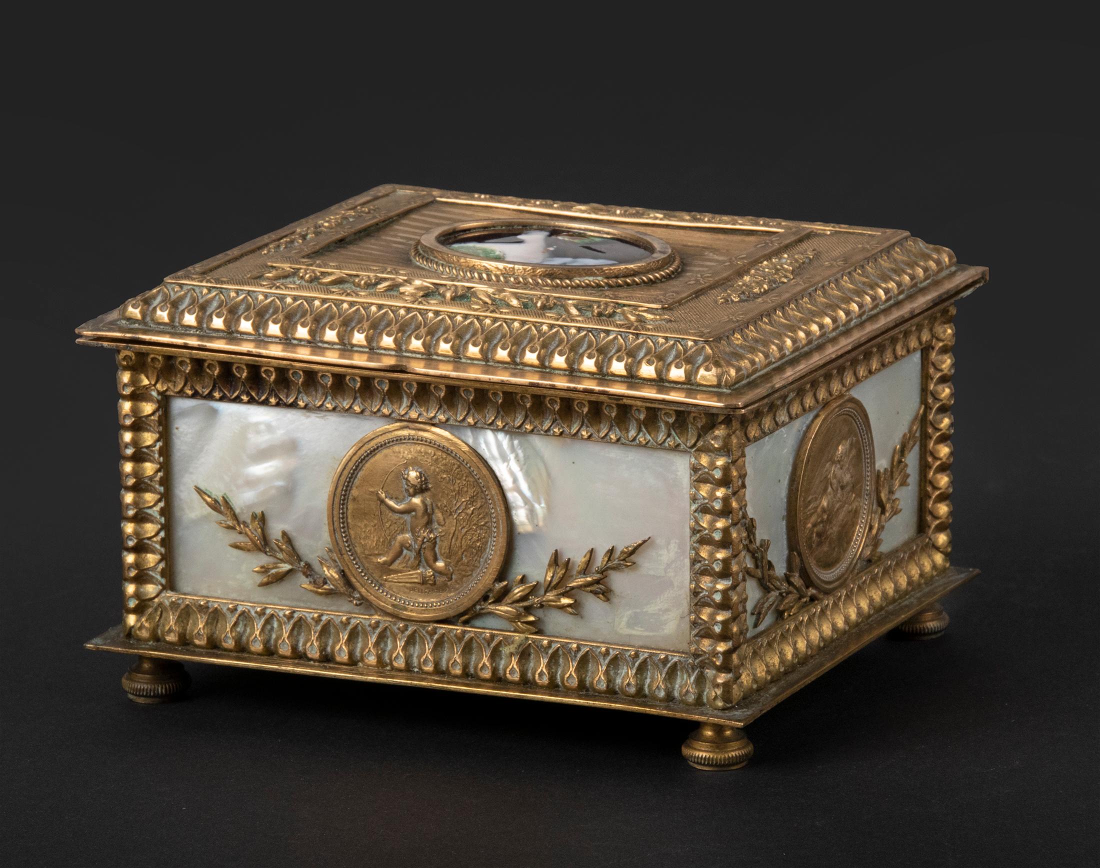Beautiful antique jewelry box from France, dating from around 1880. The box is made of bronze, it has fine etching work and is inlaid with mother of pearl. In the middle of the lid is a beautiful miniature portrait of a young woman, this is an