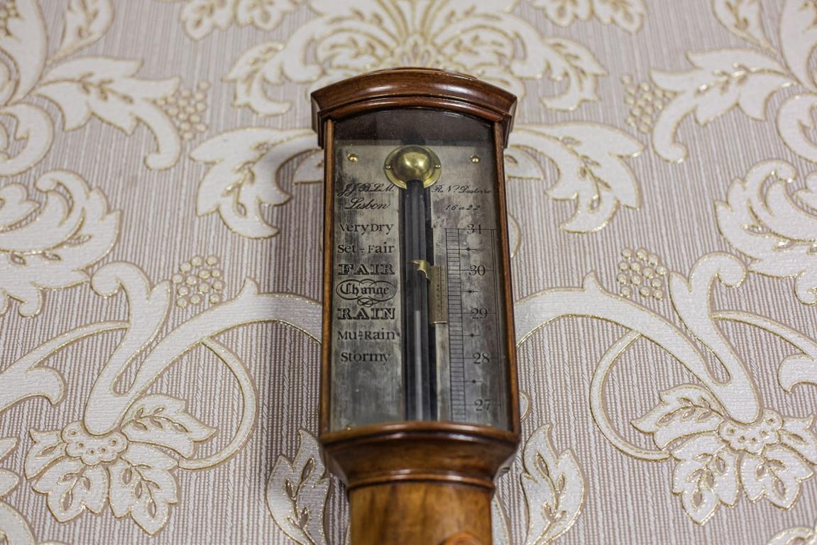 We present you a mercury barometer with a thermometer in the Fahrenheit scale.
This item is from the early 19th century.
The wooden case is in the Biedermeier style. The barometer scale is engraved on the dial.

Presented item is functional. The