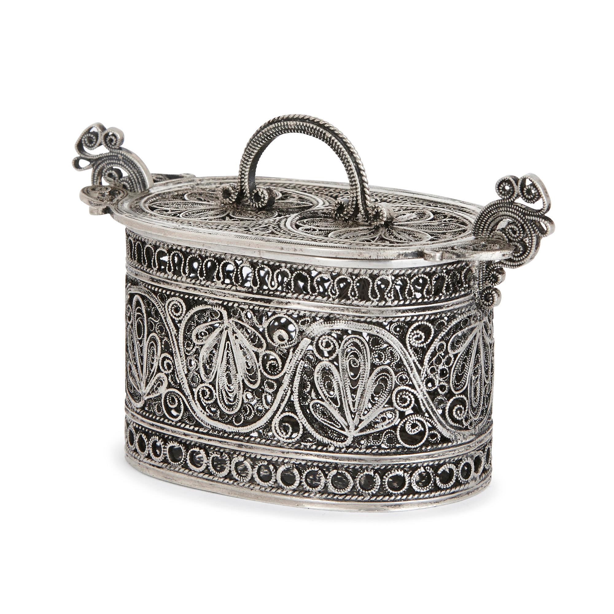 This silver box is an exquisite piece of Jewish ceremonial art. It is designed to hold the aromatic Besamim spices, which are passed around the synagogue during a Havdalah ceremony. This ceremony marks the end of the Sabbath (seventh day of the