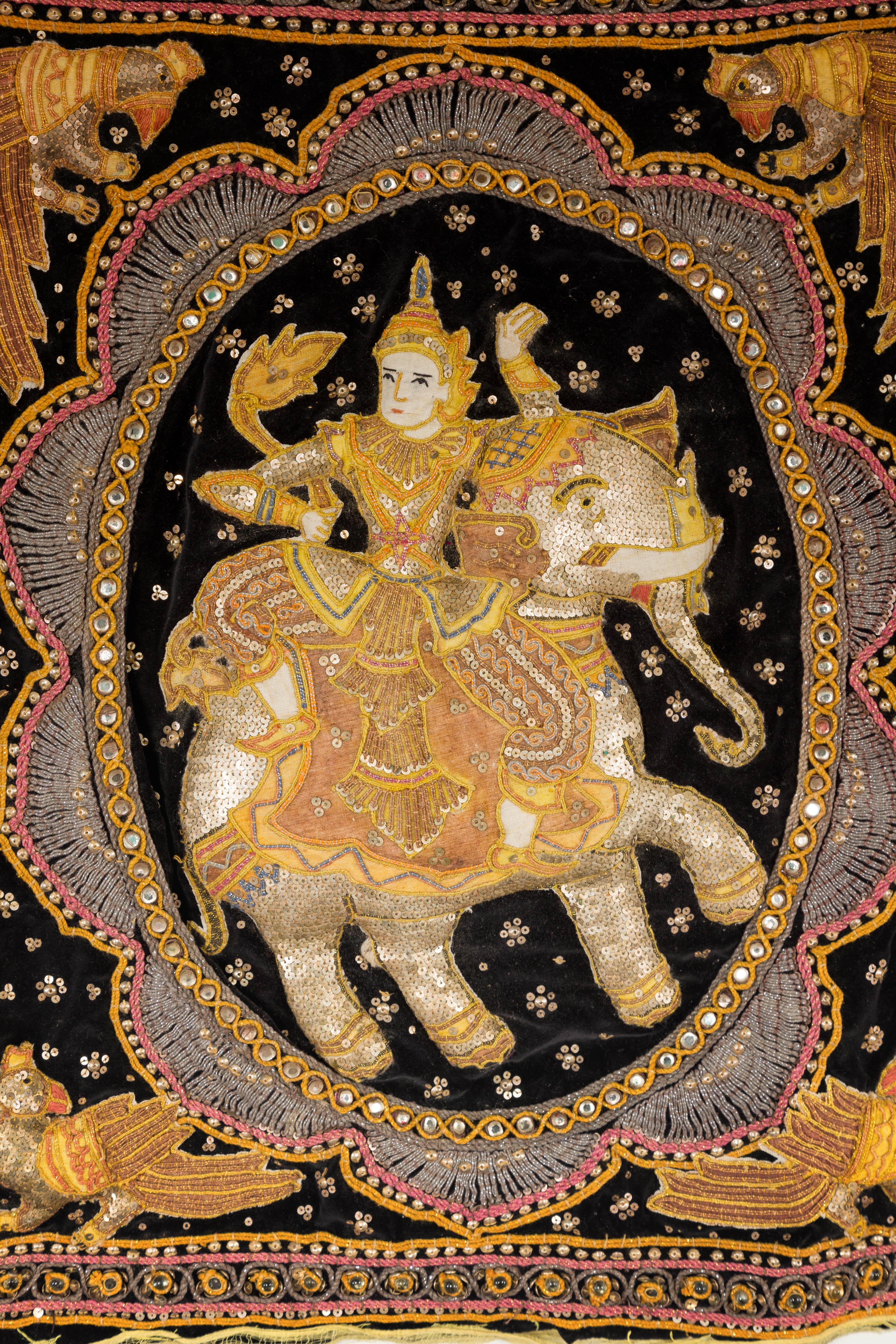 A 19th century Burmese Kalaga velvet tapestry with stones, sequins and colorful thread. Immerse yourself in the grandeur of Burmese craftsmanship with this captivating 19th-century Kalaga tapestry. A cultural treasure from Burma (now Myanmar), this