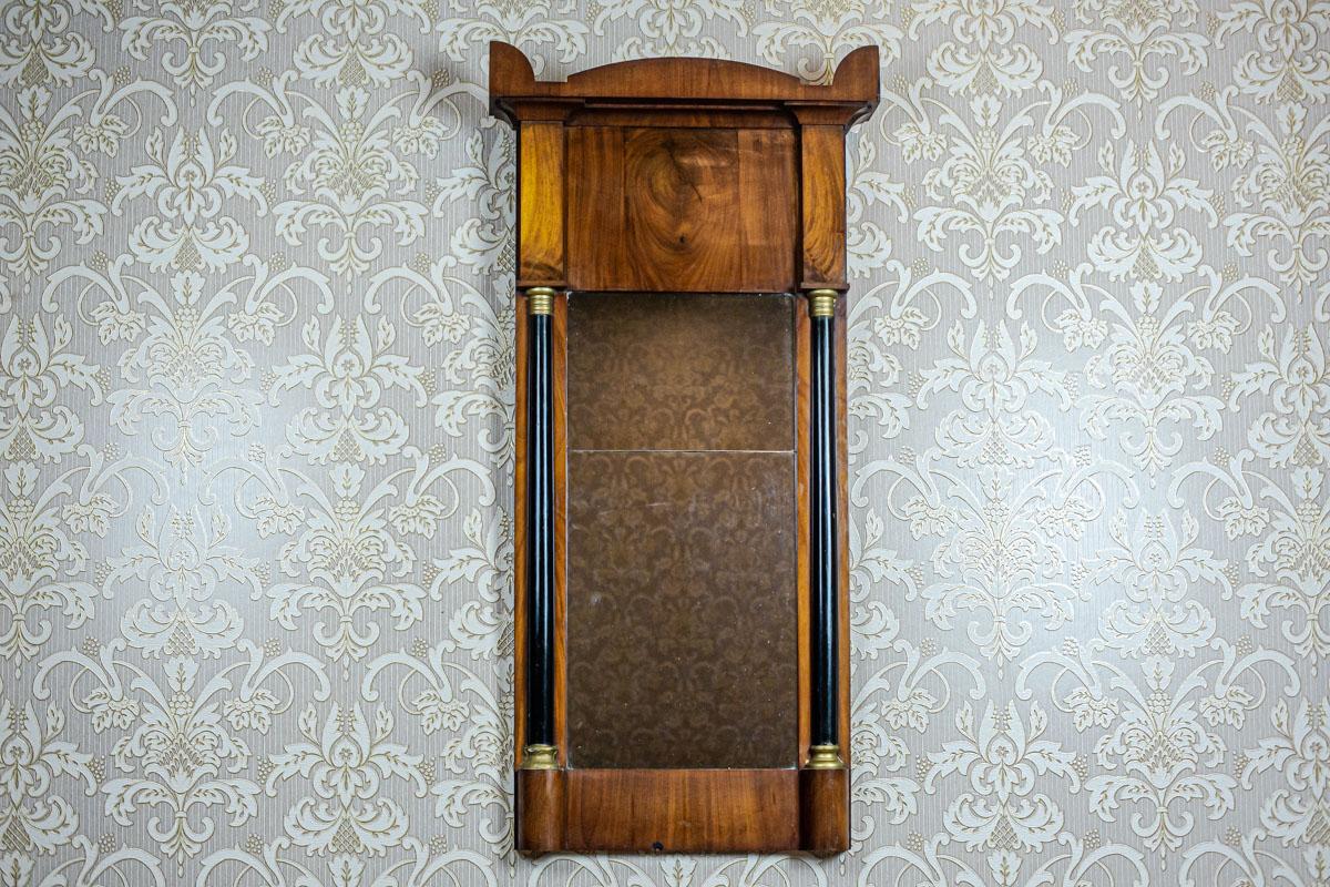 We present you narrow, rectangular mirror in a wooden frame veneered with mahogany.
The whole is from the 1st half of the 19th century.
The frame is in the Karl Johan style, Swedish variation of Biedermeier.

This mirror is old, composed of two