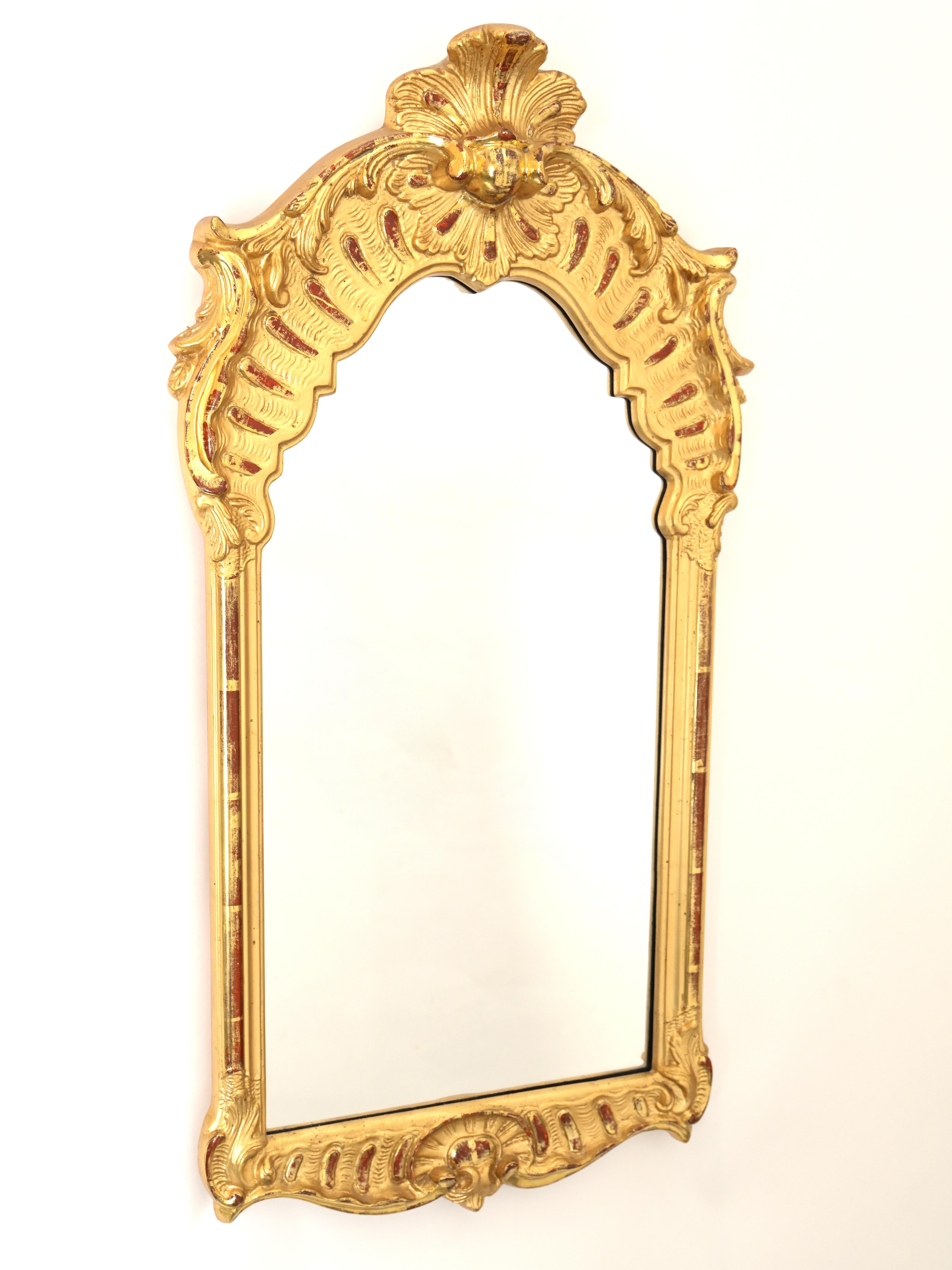 A 19th century Swedish Karl Johan Gilted mirror with ornate scallop wood carvings around the frame. c. 1830.