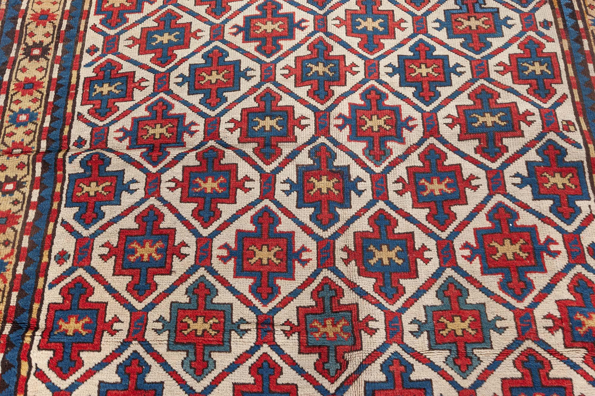 19th century Kazak handmade wool rug in red, yellow and blue
Size: 4'4