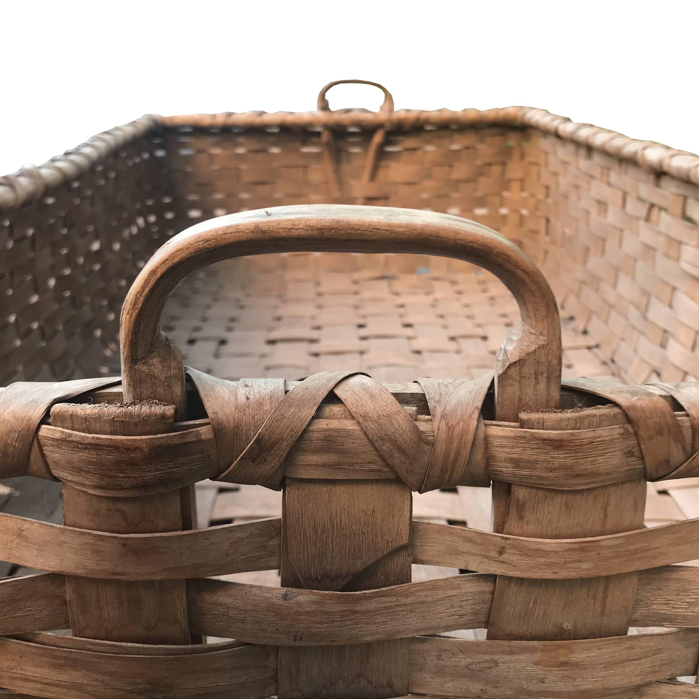 A rare 19th century Kentucky splint ash tobacco leaf basket of rectangular form with double-banded rim, wooden handles, and a wide flat bottom.