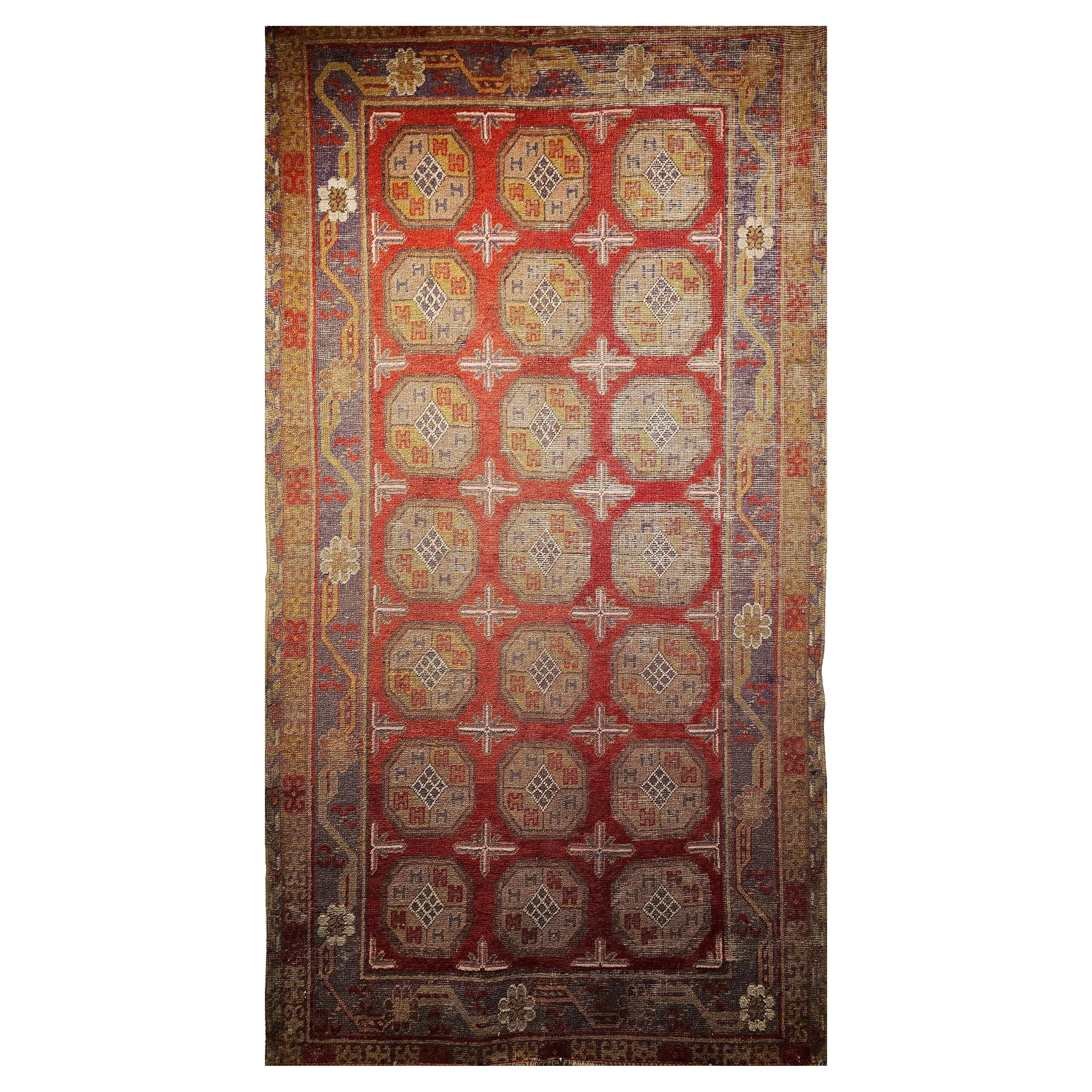 19th Century Khotan Rug with Allover Medallion Pattern in Red, Lavender, Ivory