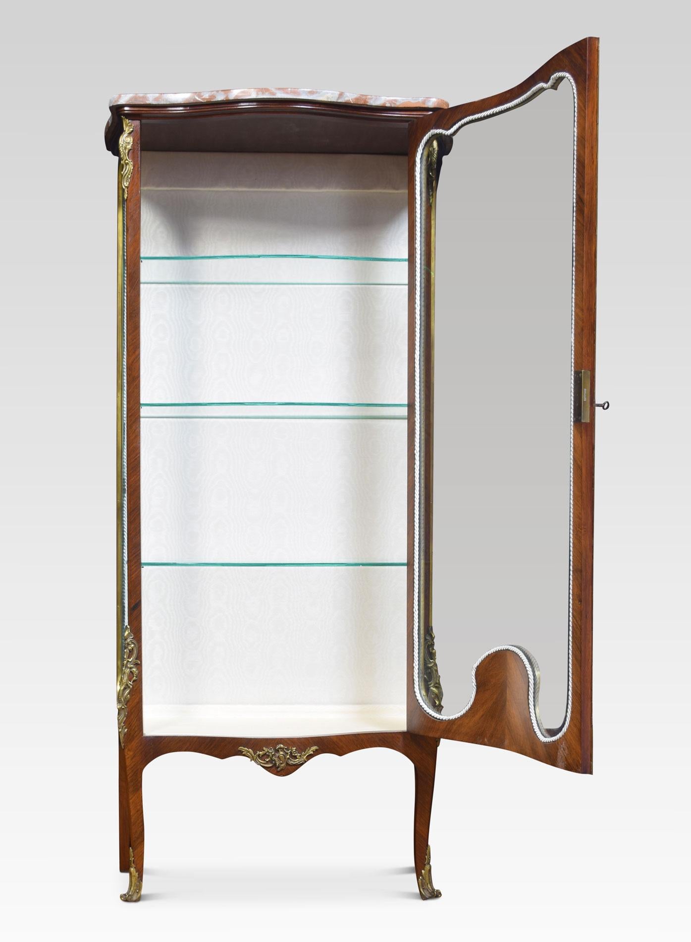 19th-century walnut and marquetry cabinet, the serpentine brocatello marble top above gilt metal mounted door with marquetry inlay. The door opening to reveal an upholsterers interior with three glazed shelves. All raised up on four cabriole legs