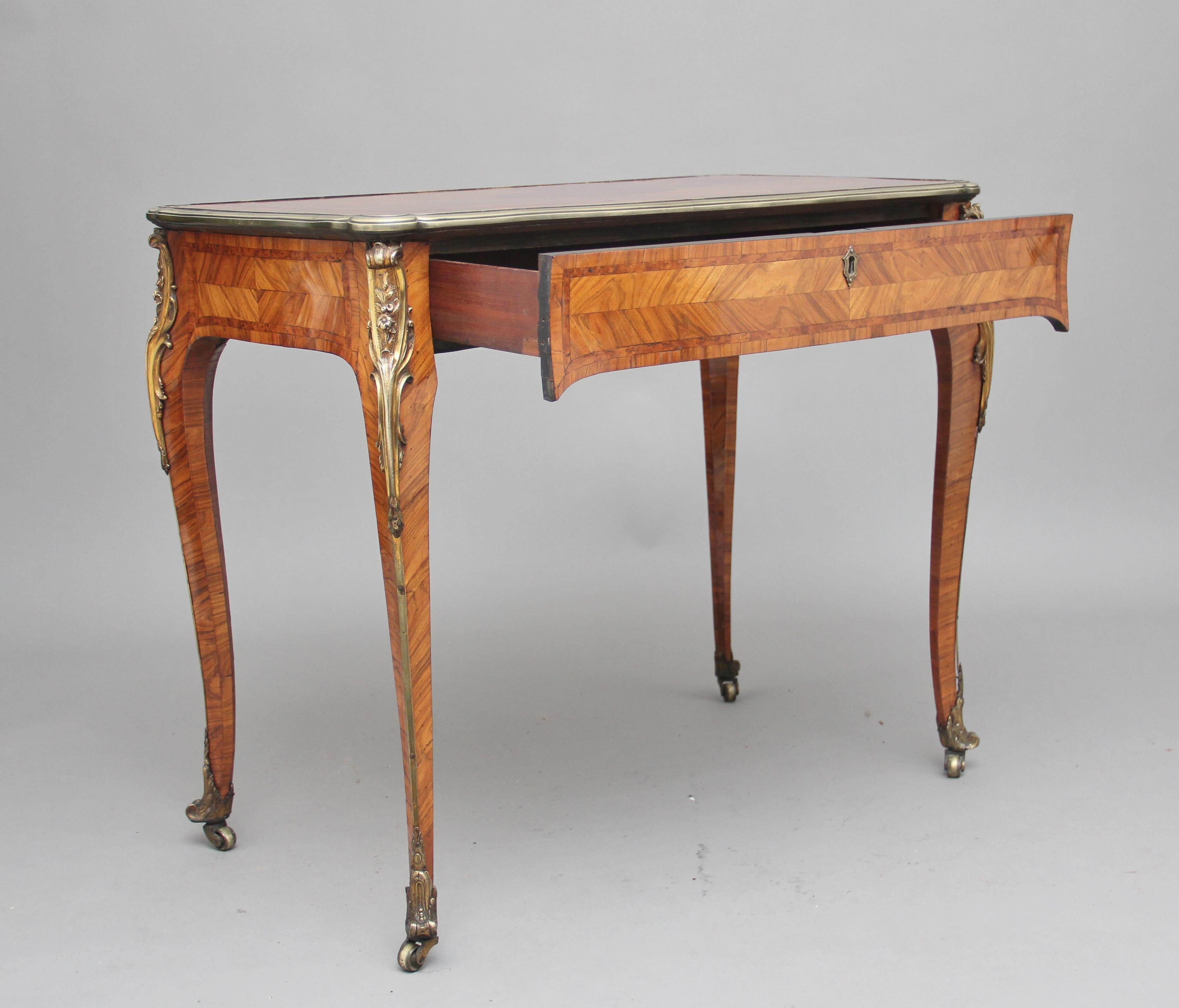19th century French kingwood centre or side table, the top having a gilt metal moulded edge with a crossbanded, quarter-veneered top inset with a thuya wood oval reserve and band, a single frieze drawer below, lovely quality gilt mounts placed at