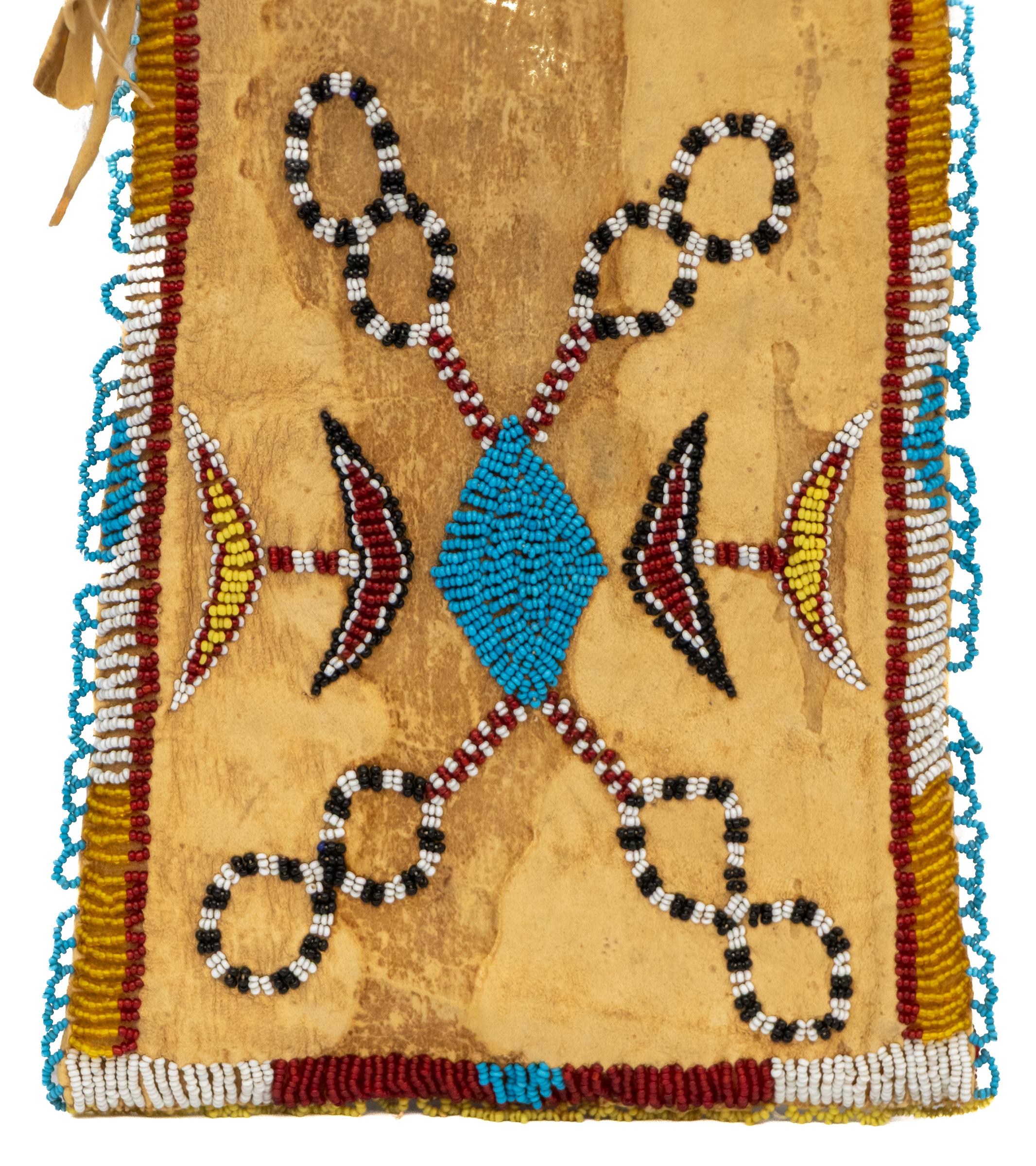 This rare and beautifully preserved 19th-century Kiowa-Apache hide bag is an exceptional example of Native American Plains artistry and craftsmanship. Expertly hand-stitched from native-tanned animal hide, the bag is richly embellished with