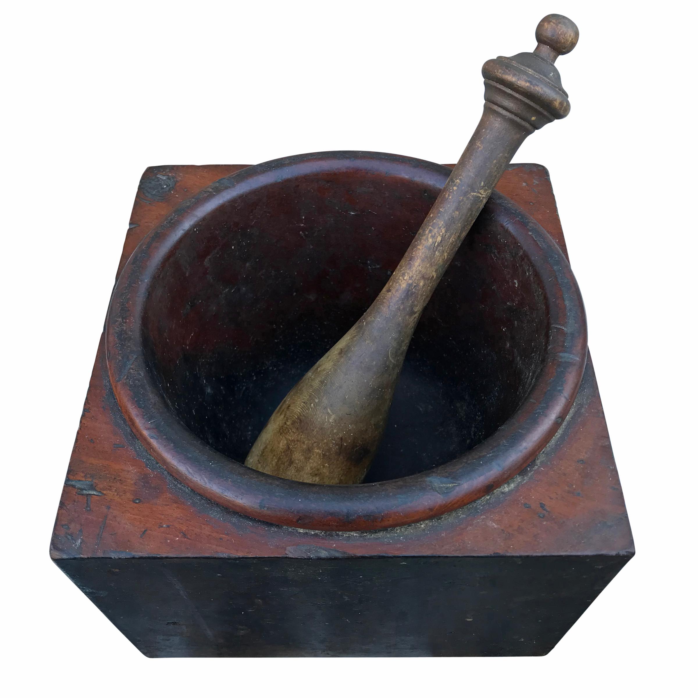 A fantastic 19th century American kitchen hardwood mortar with a turned softwood pestle. It’s likely that this mortar would have lived in a larger wood or marble holder, and removed when necessary. Two small holes on the bottom would have held the