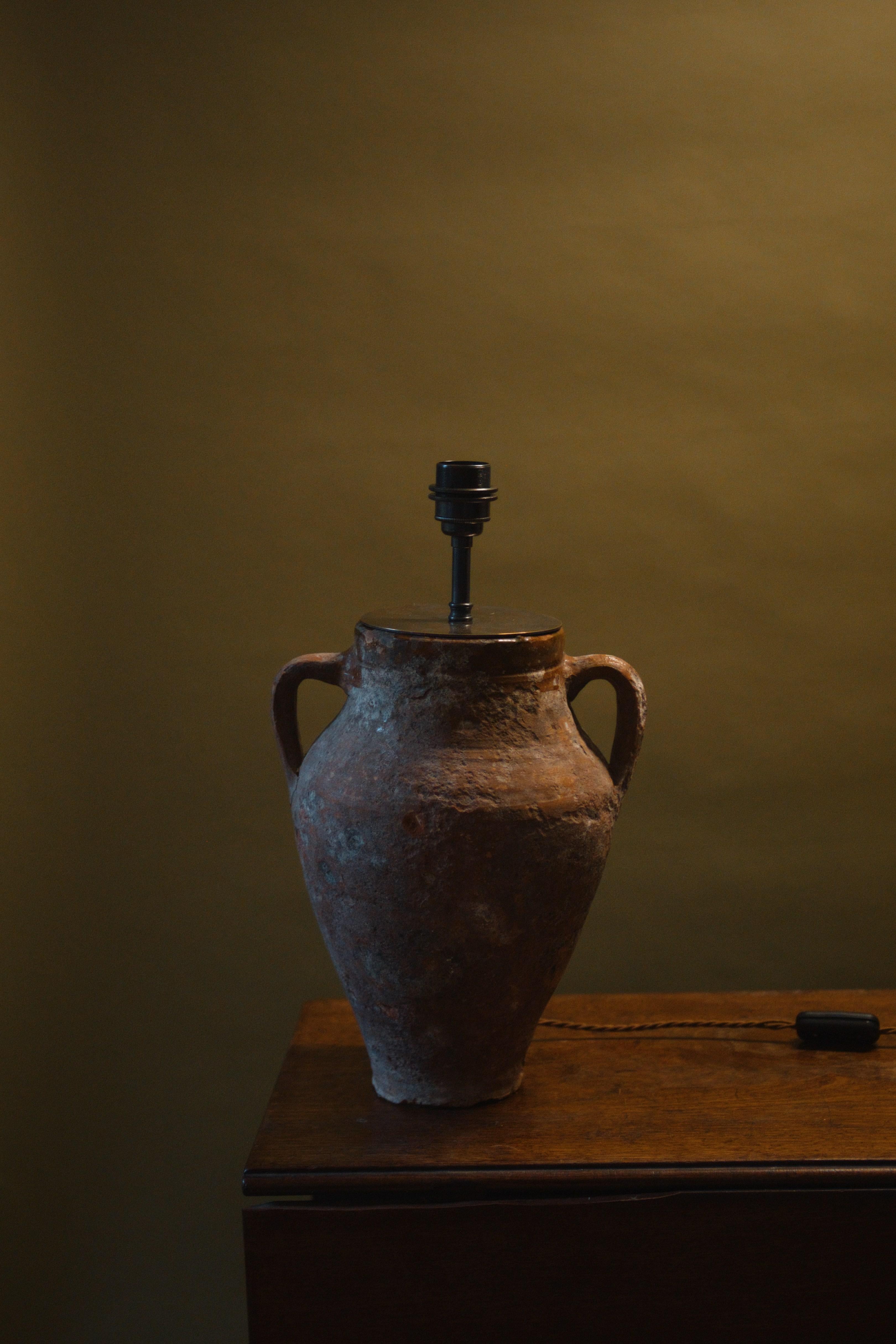 This 20th century Konya glazed pot lamp is a beautiful blend of artisan craftsmanship and timeless design. Handcrafted from a vintage Mediterranean clay pot with over 60 years of history, it features a unique glazed finish that adds depth and