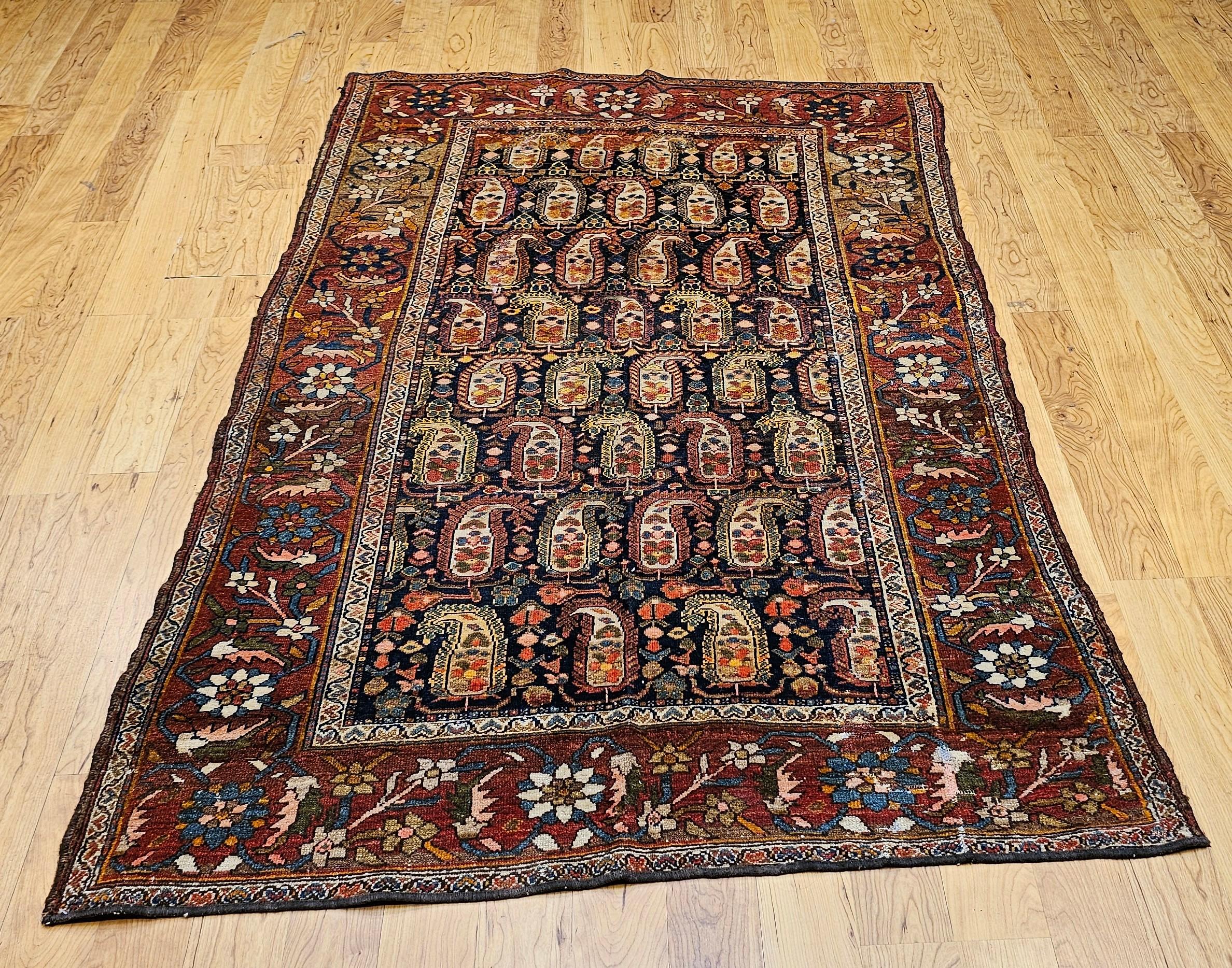 Be enchanted with the whimsical charm and exceptional artistry of this vintage Persian Kurdish area rug from the late 19th century.  The rug features a beautiful and highly desirable allover paisley design, with a captivating twist: each paisley