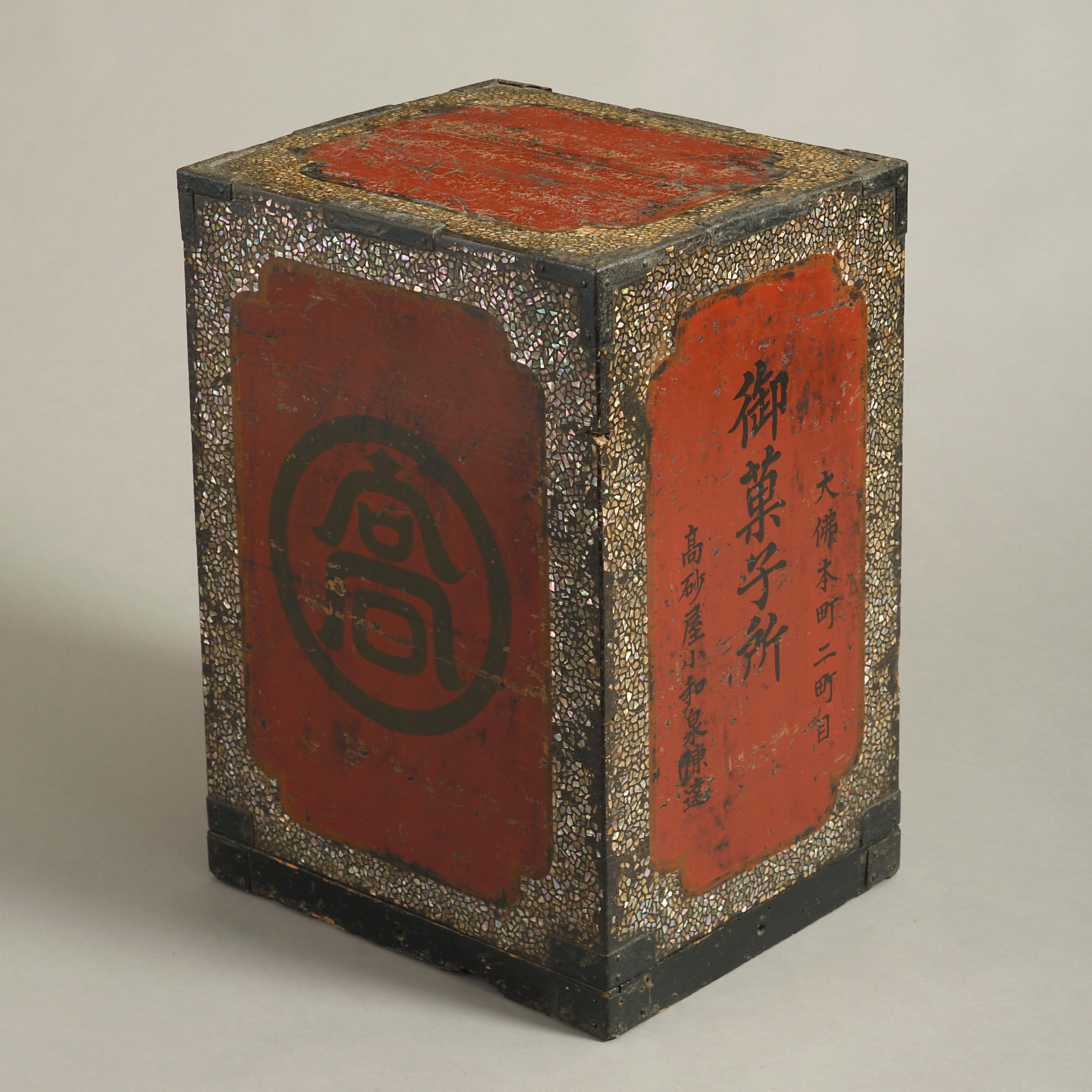 A fine 19th century lacquer armour box, of rectangular form, the sides decorated with black painted character marks and mother of pearl on a red ground.