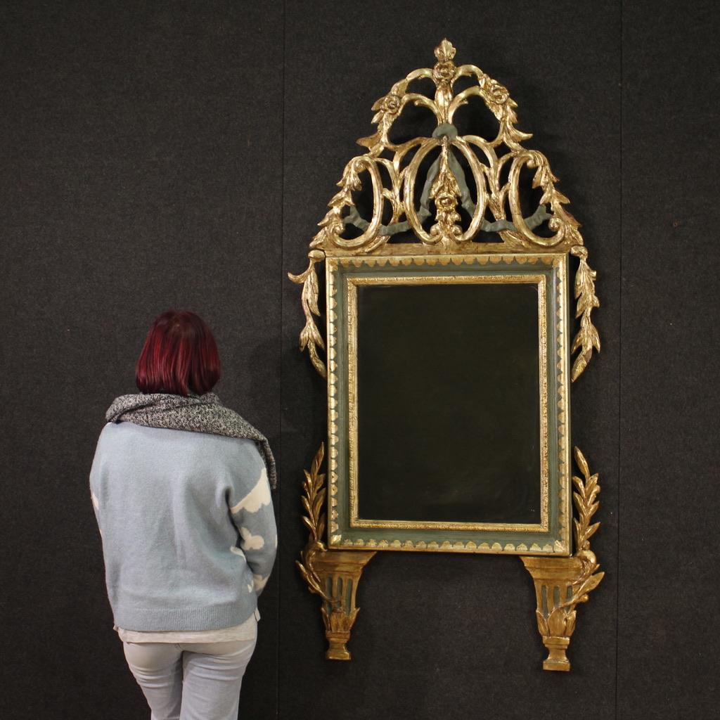 Italian mirror from the first half of the 19th century. Furniture in carved, lacquered and mecca-gilded wood (silver colour) in Louis XVI style. Mirror of beautiful size and proportion supported by wooden feet and adorned with a rich cymatium with
