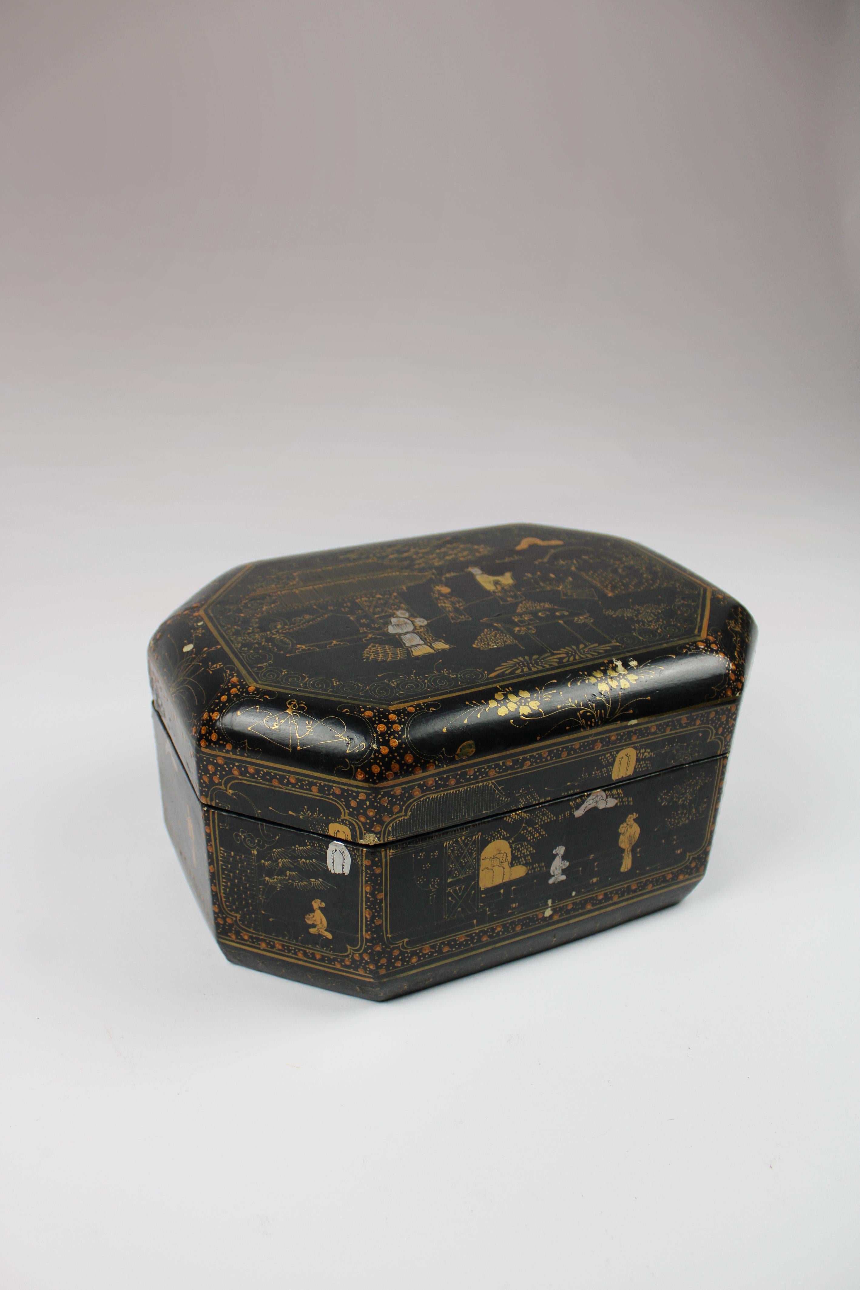 Immerse yourself in the allure of the 19th century with our exquisite lacquered box, a stunning testament to Chinese export craftsmanship. Crafted in an elegant octagonal shape and adorned with rich black lacquer, this box exudes sophistication and