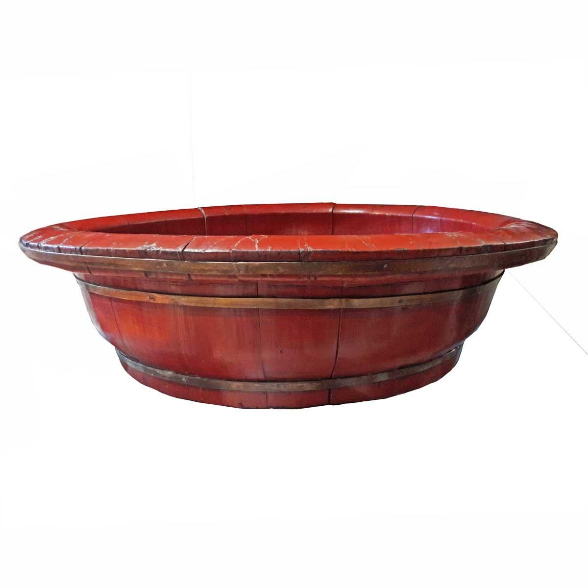 A large Chinese basin or bowl crafted out of peachwood, with red lacquer and forged bronze braces, circa 1880.