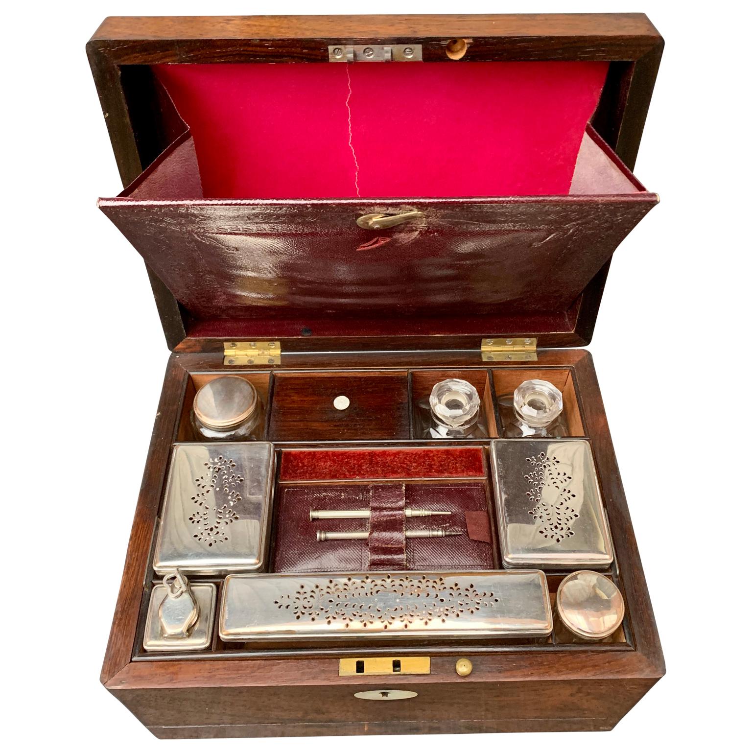 A 19th century oakwood vanity box with different accessories included. The box has the owner's initials of 