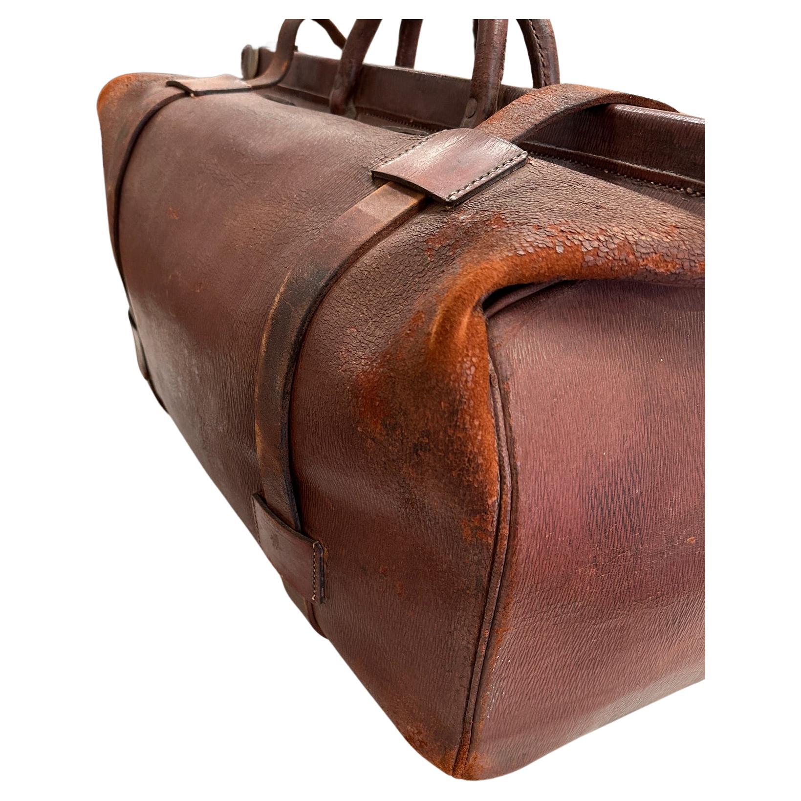 This beautiful 19th Century large scale Antique leather traveling bag or luggage is truly a special piece.  The bag opens and all of the brass hardware is in working condition. The bag is in the shape of a Dr's medicine bag but much larger - like a