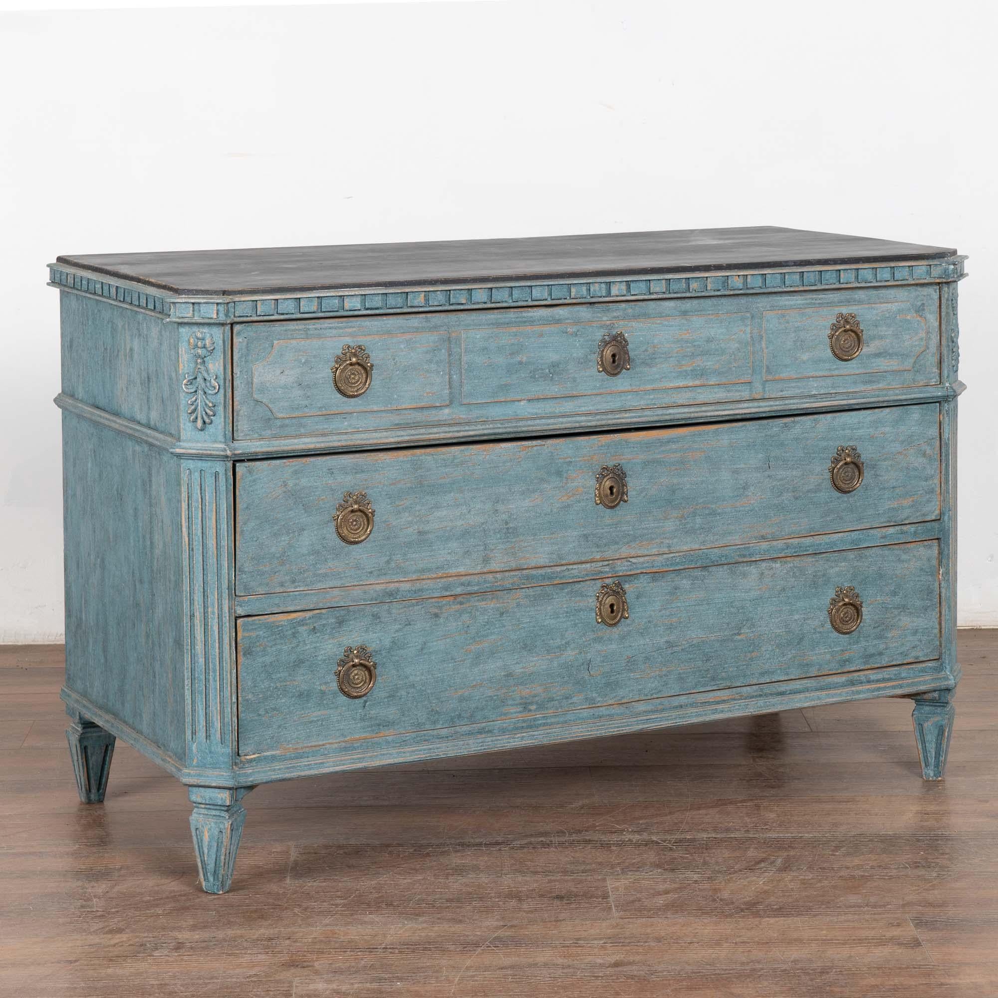 This lovely Gustavian pine chest of drawers has the simple yet elegant lines that reveal its Swedish country style. The hard to find size is large at 4' wide.
The carved dentil molding along top, canted fluted side details and gently tapered fluted