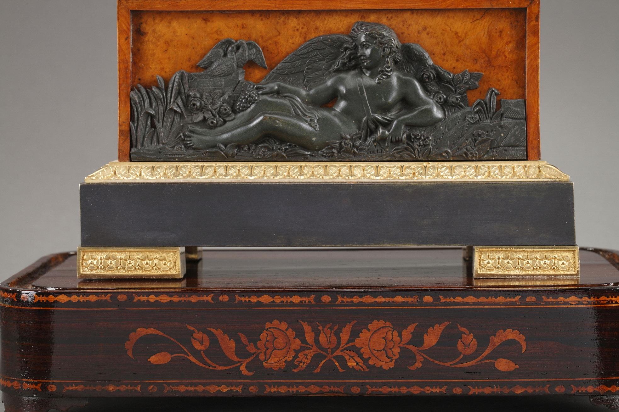 A stunning Restauration lyre clock crafted of burr elm veneer with hand-chiseled gilt and patinated bronze decoration. Rich foliage and floral motifs surround the ormolu dial, which is lined with petals. The dial ring is embellished with roses and