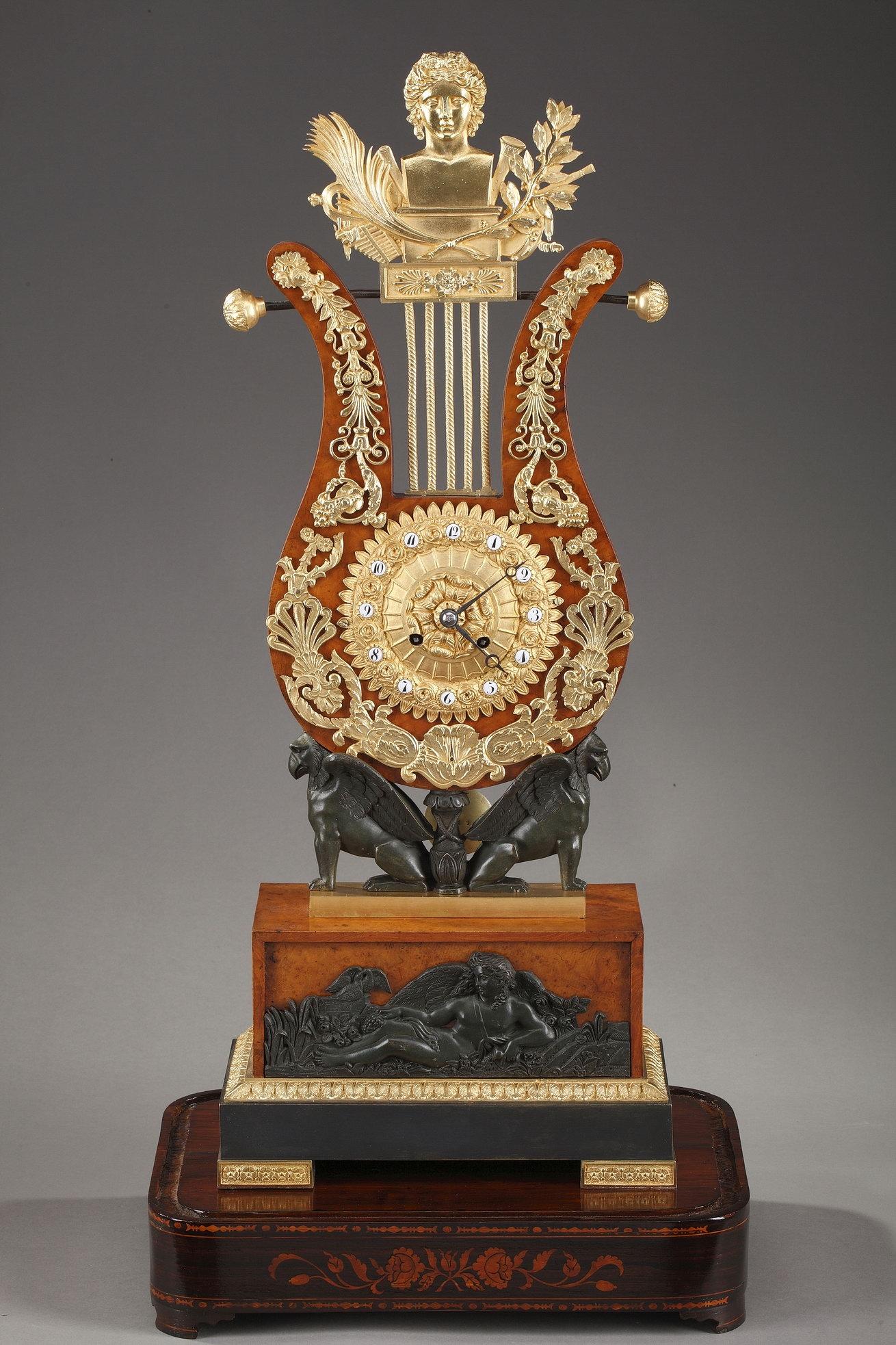 A stunning Restauration lyre clock crafted of burr elm veneer with hand-chiseled gilt and patinated bronze decoration. Rich foliage and floral motifs surround the ormolu dial, which is lined with petals. The dial ring is embellished with roses and